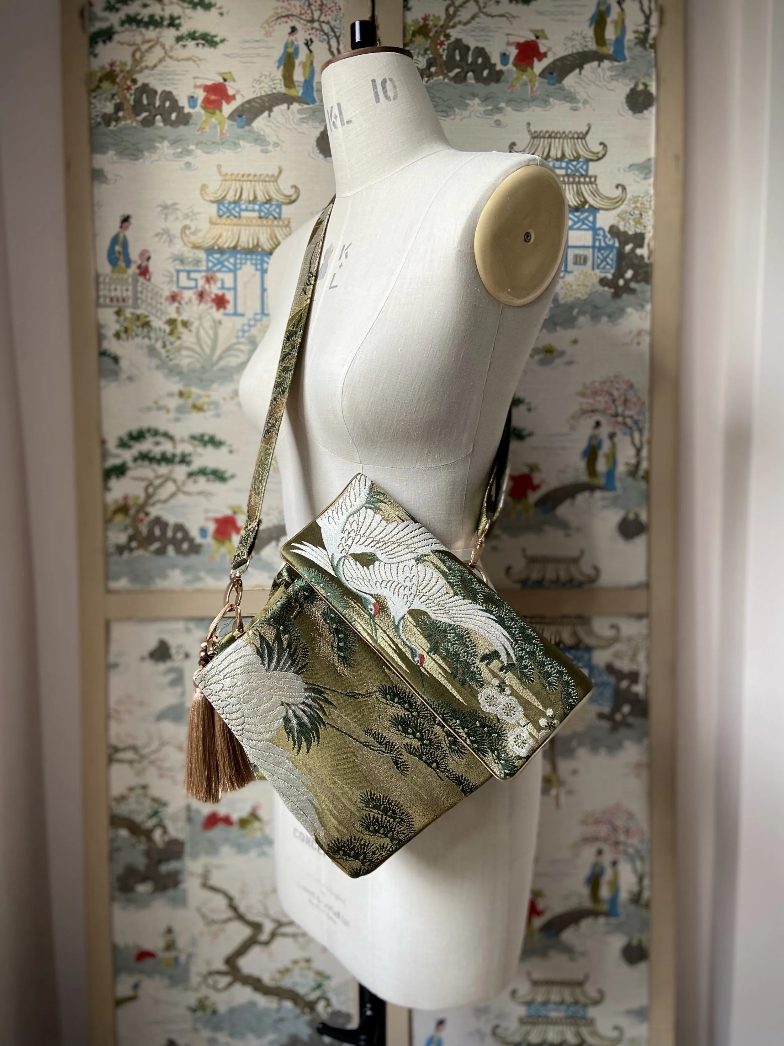 Green and gold vintage obi silk shoulder bag with crane, pine and chrysanthemum design, gold hardware and matching fabric tassel charm by Kirsty Chivers