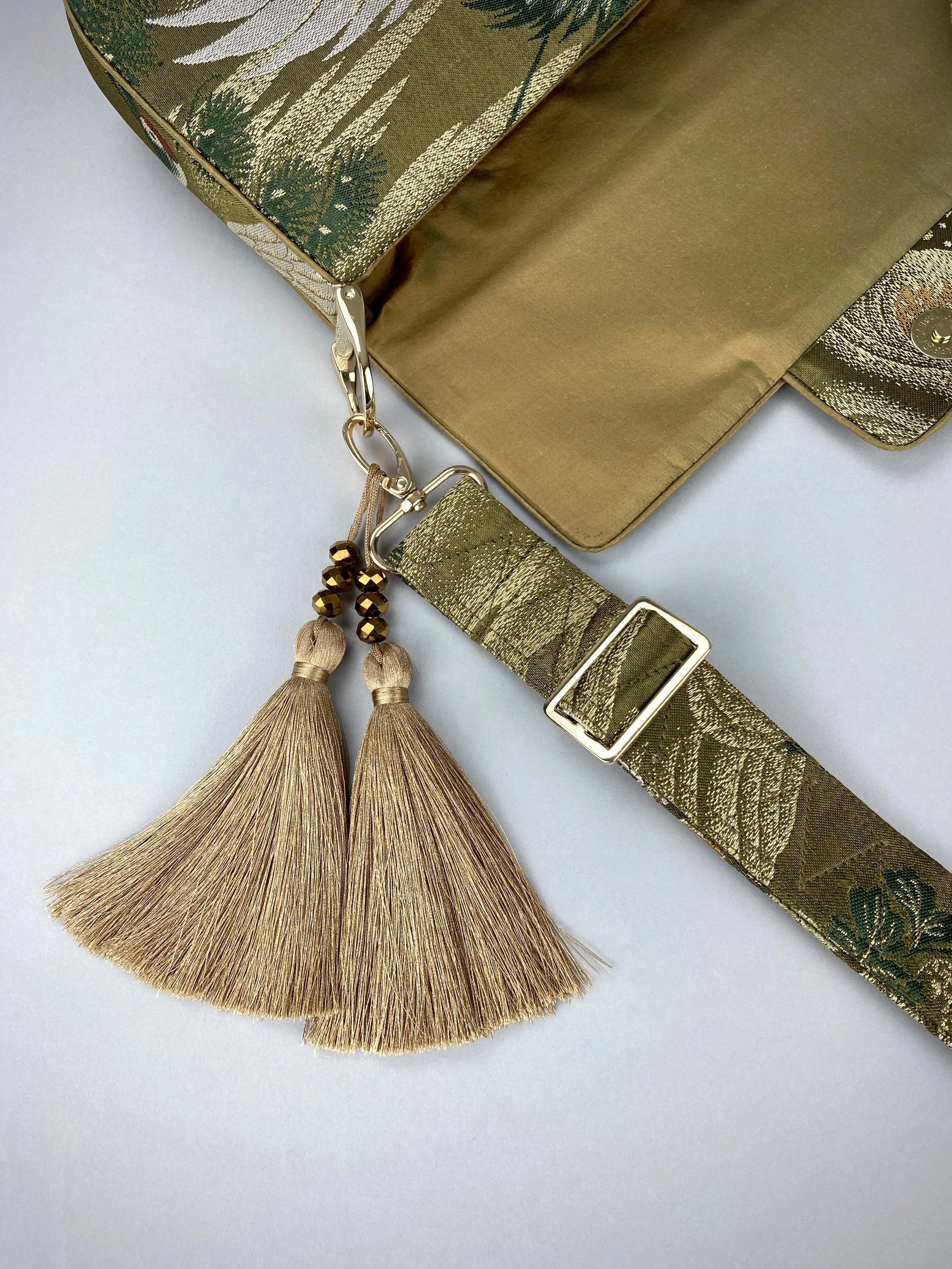 Unique Flying Crane baguette bag, handmade from vintage Japanese obi silk with gold hardware and matching silk tassel charm by Kirsty Chivers