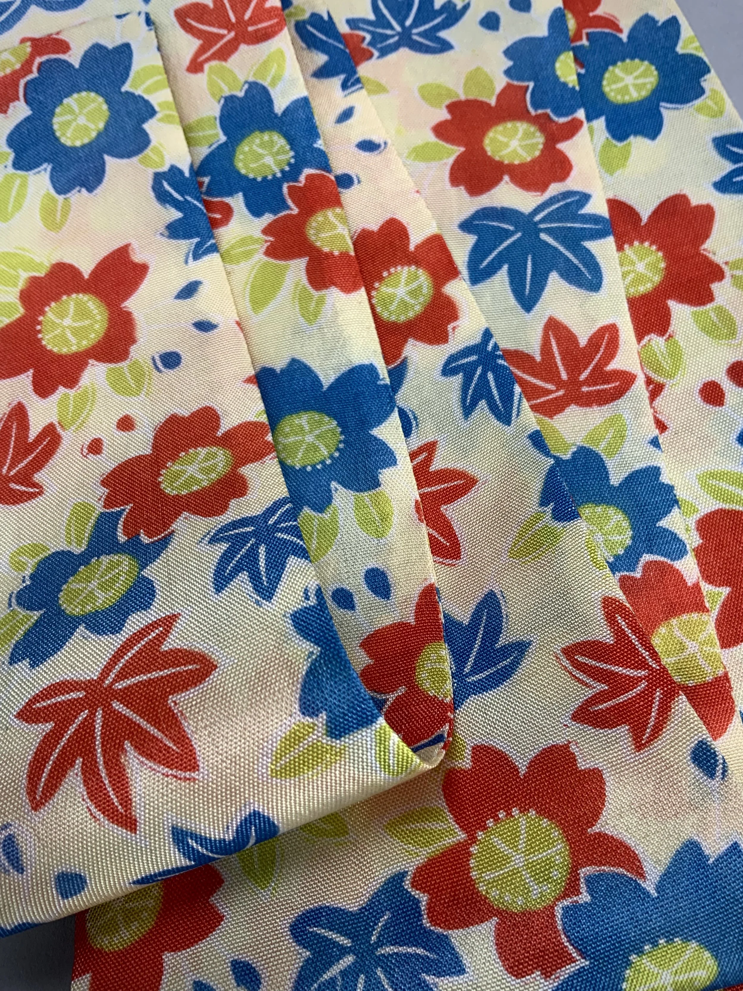 Closeup of butter yellow skinny scarf with Cherry blossom & Maple leaf print, handmade by Kirsty Chivers