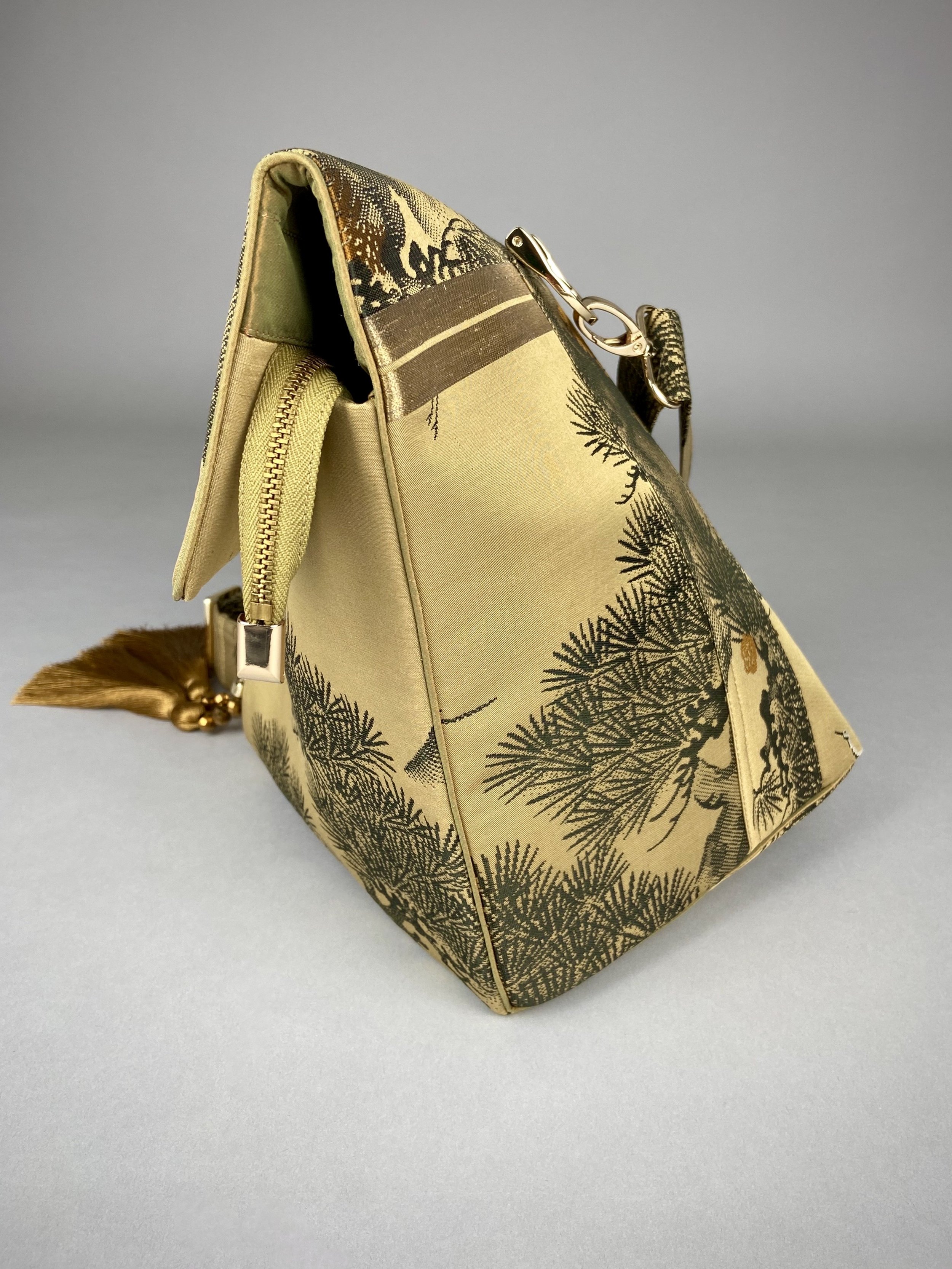 Olive green Matsu pine vintage obi silk shoulder bag with crane design, gold thread detailing and matching fabric tassel charm by Kirsty Chivers