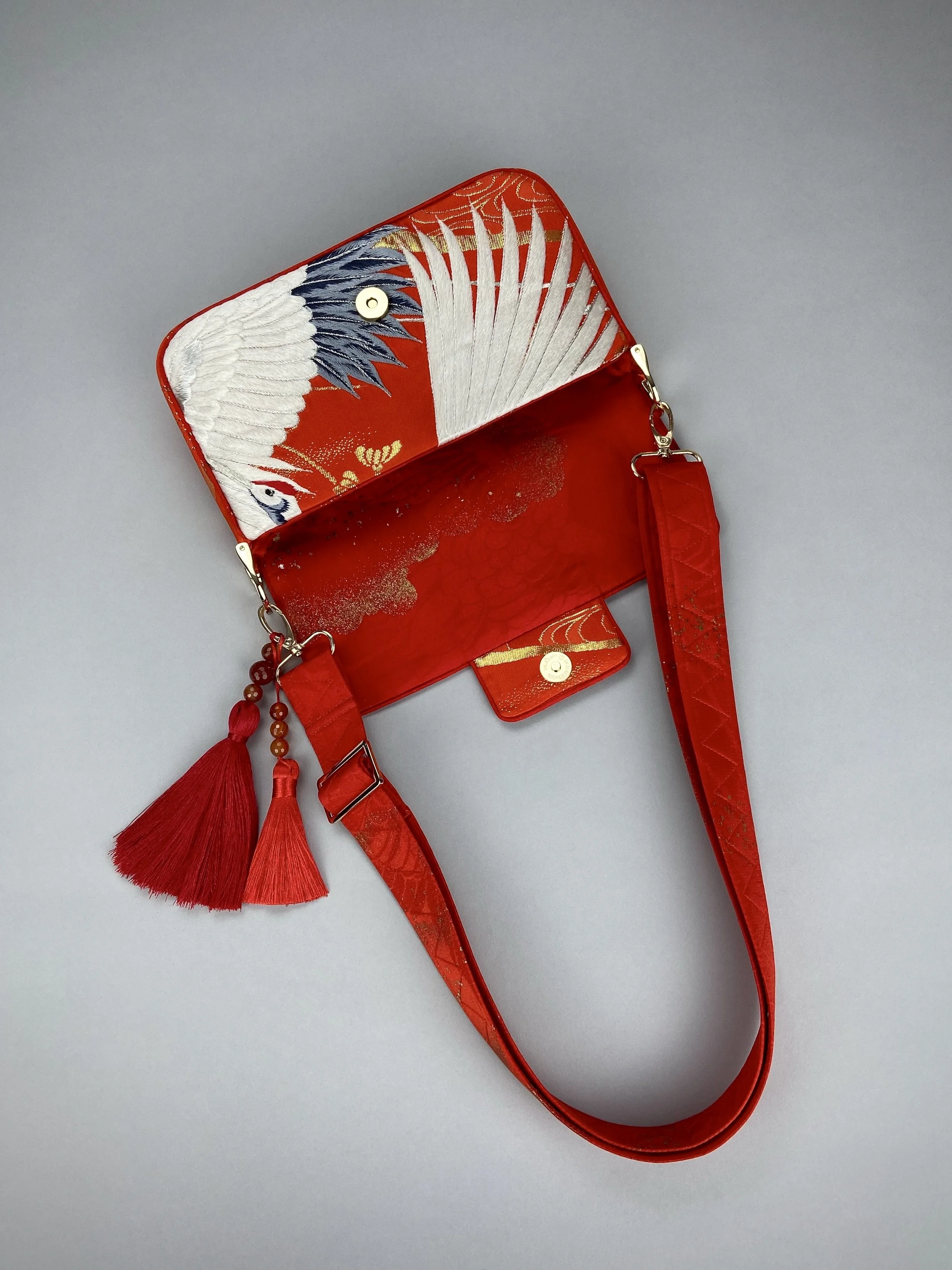Vermillion Crane Feather baguette bag, made from vintage Japanese kimono silk, with gold hardware and Agate beaded tassel charms by Kirsty Chivers