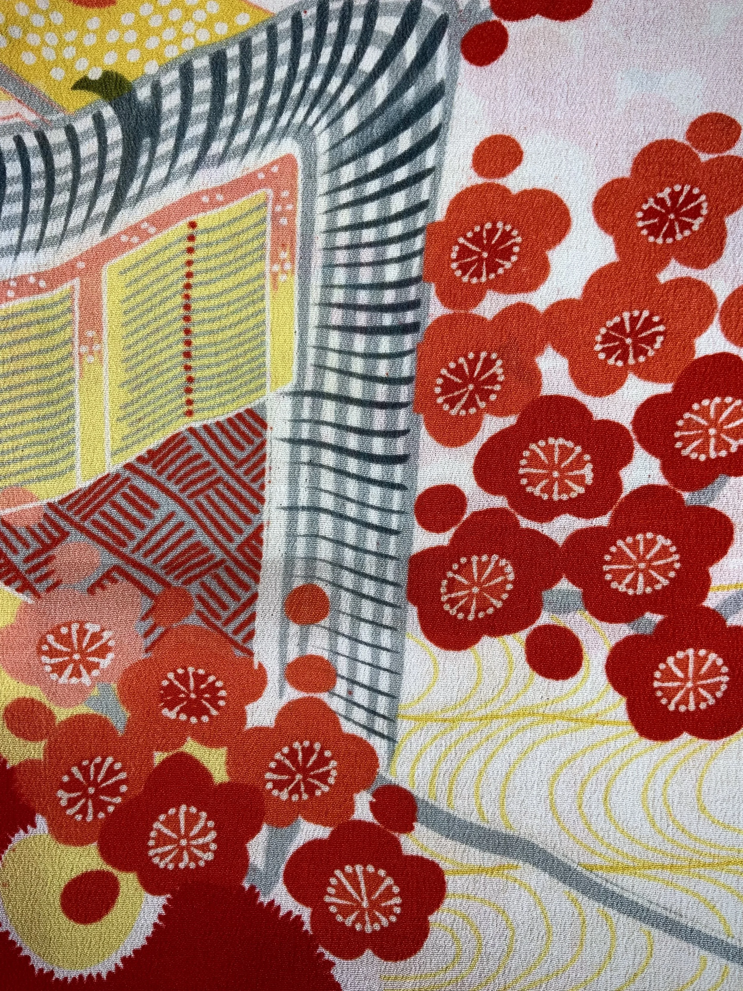 Closeup of vibrant red and yellow scarf with printed blossom design, handmade from repurposed Japanese kimono crepe silk by Kirsty Chivers