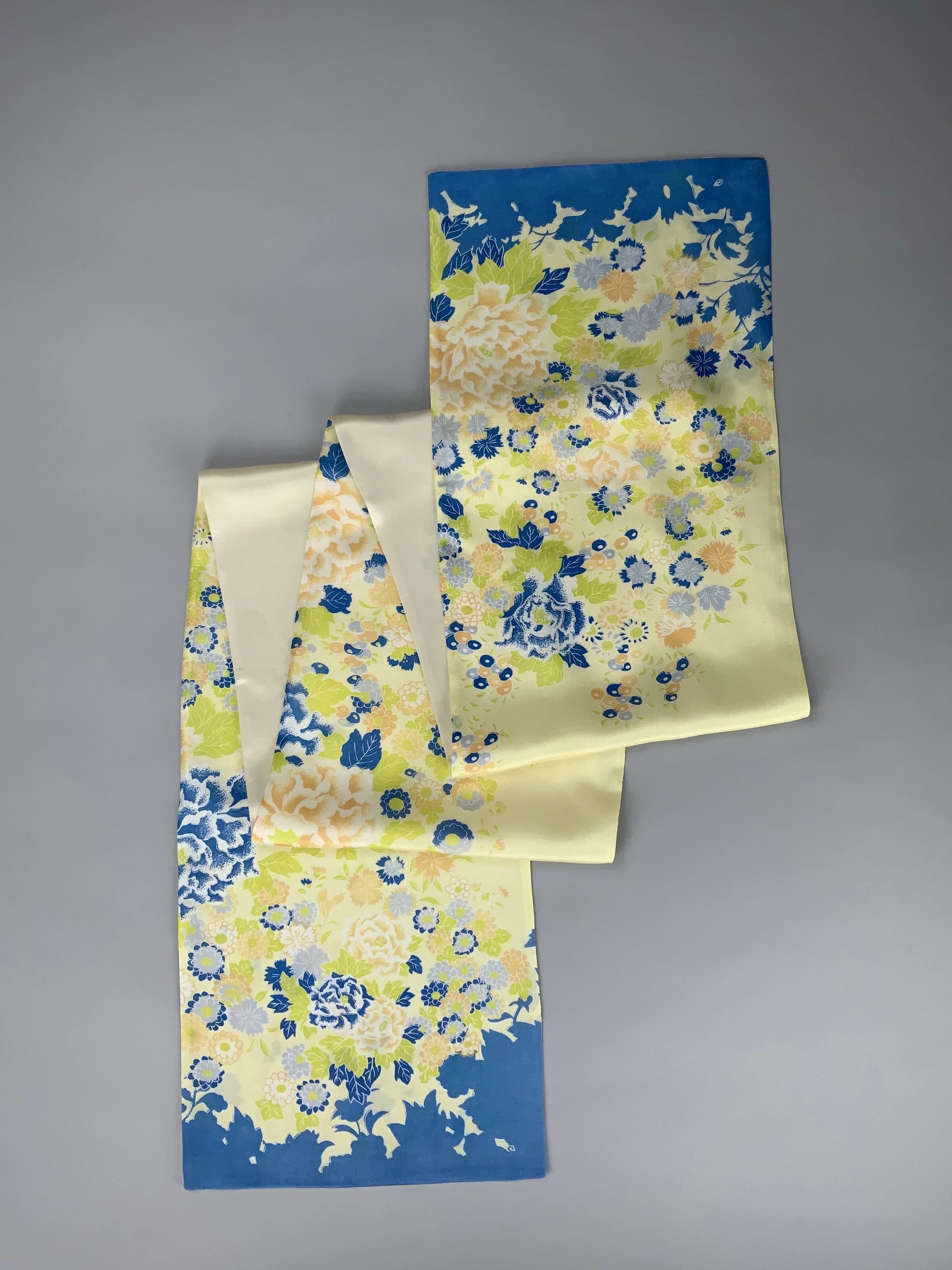 Flatlay of yellow scarf with blossom print handmade from kimono fabric and silk satin by Kirsty Chivers