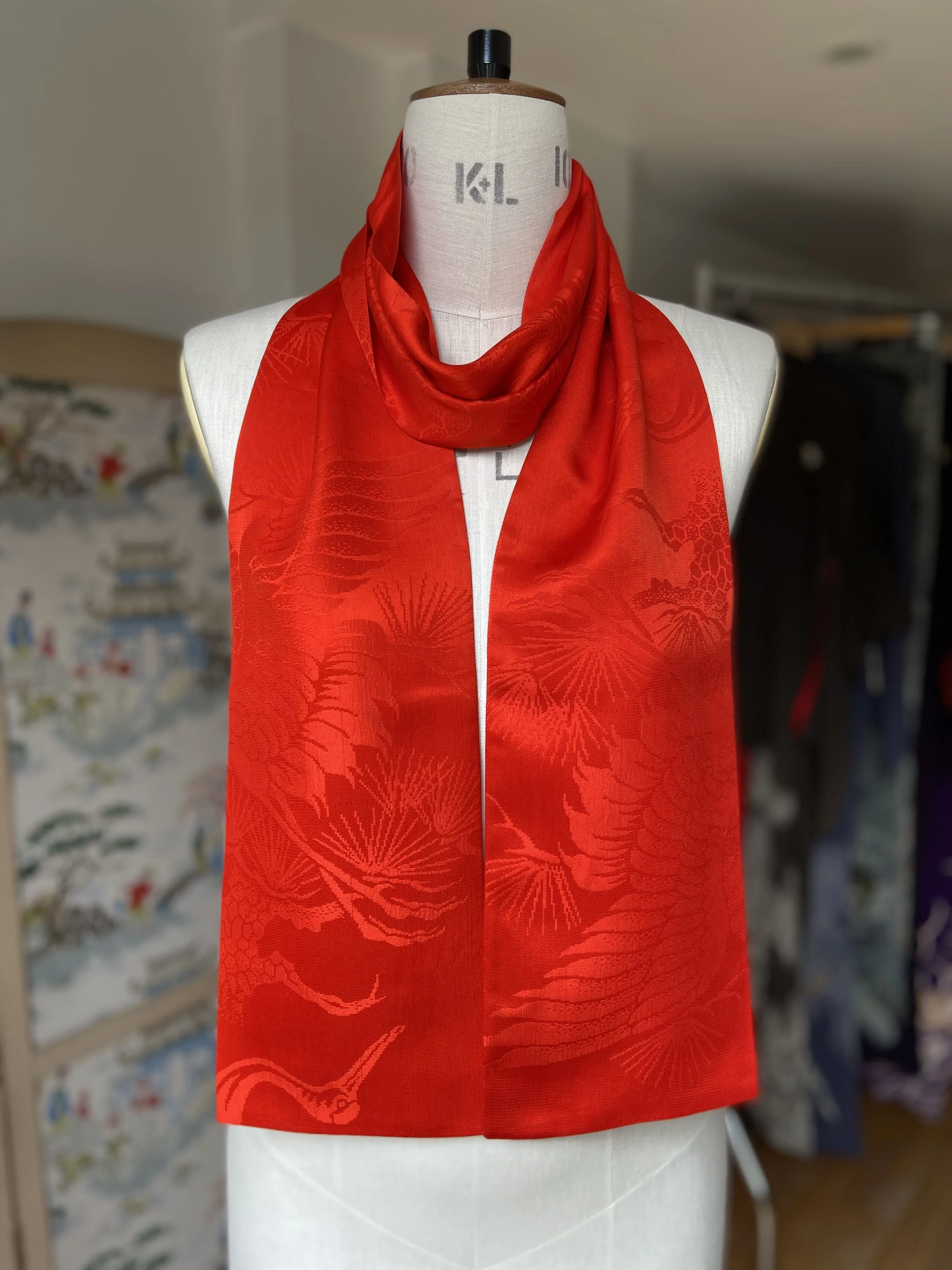 Vibrant vermillion red silk scarf crafted from kimono silk by Kirsty Chivers Handmade, displayed on a dress stand