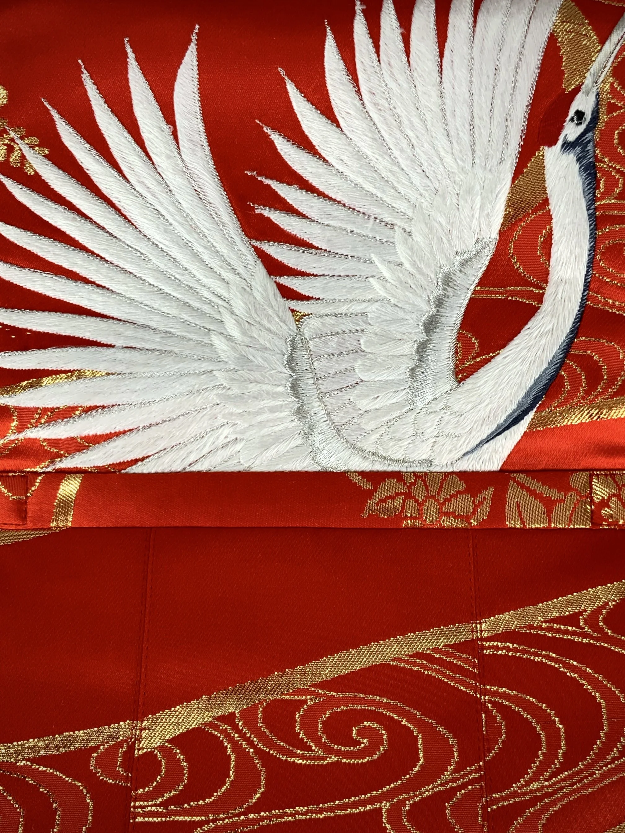 Vermillion red evening bag with embroidered crane design, handmade from vintage kimono silk by Kirsty Chivers