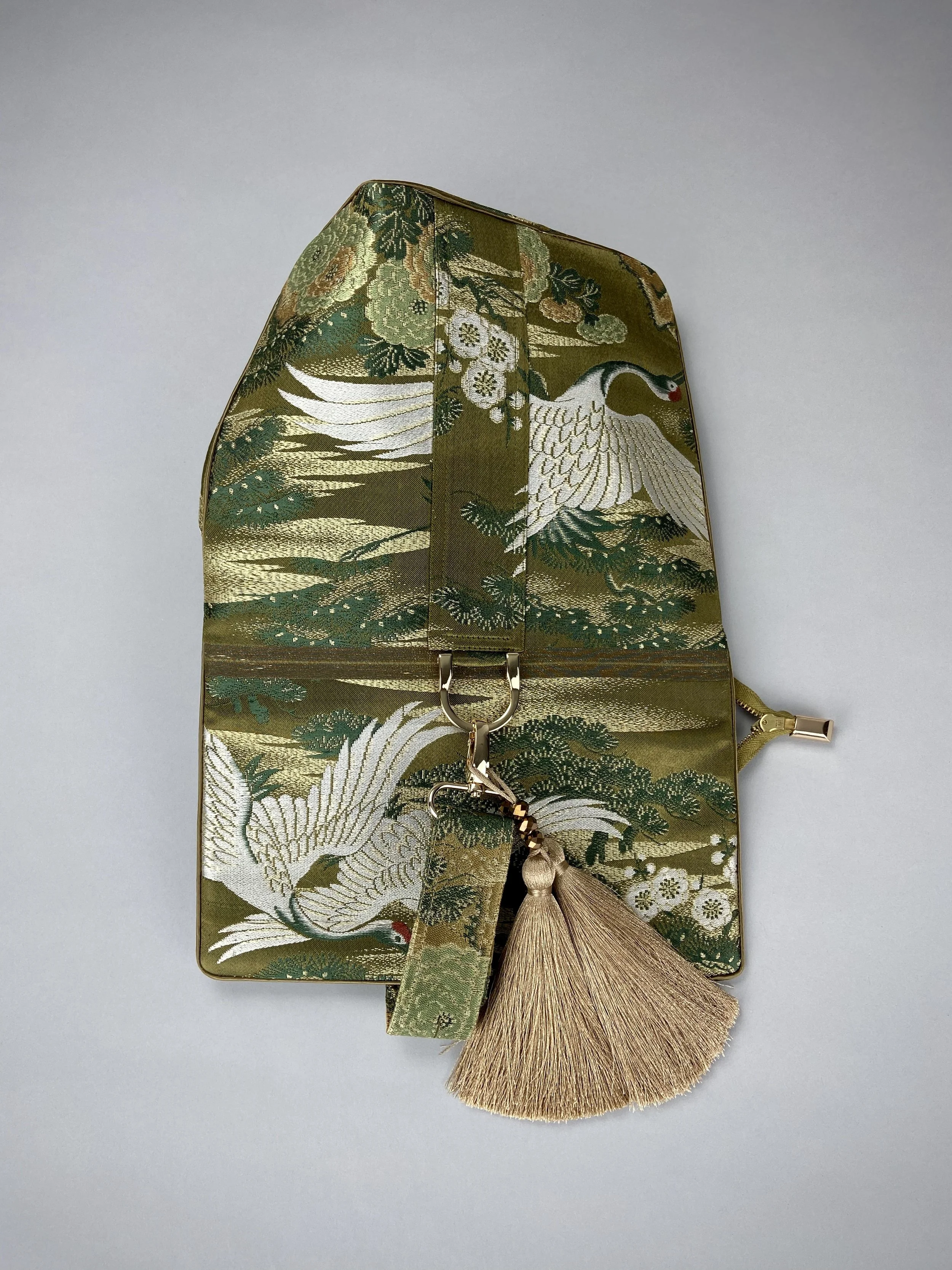 Green and gold vintage obi silk shoulder bag with crane, pine and chrysanthemum design, gold hardware and matching fabric tassel charm by Kirsty Chivers