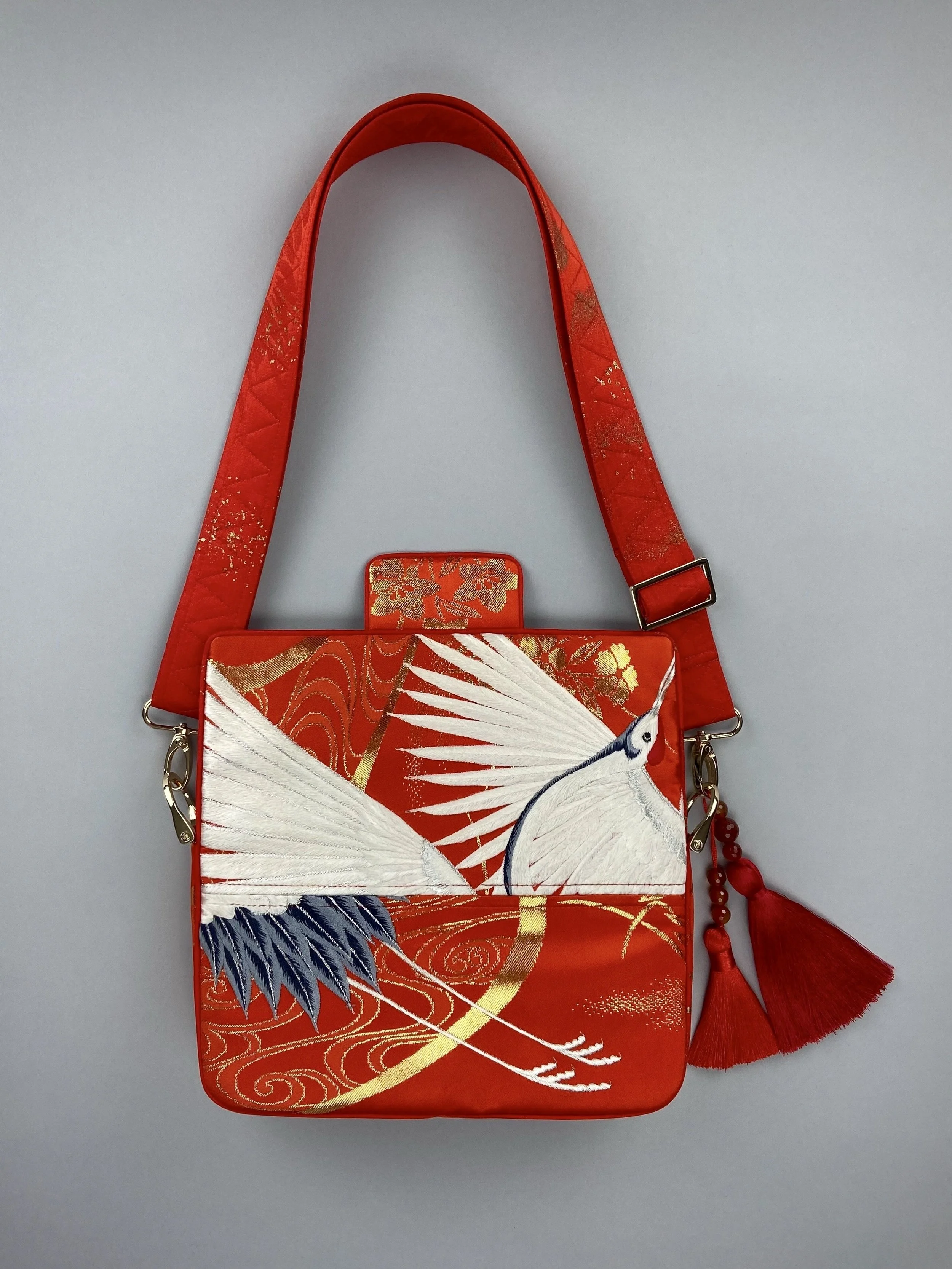 Vermillion Crane Feather baguette bag, made from vintage Japanese kimono silk, with gold hardware and Agate beaded tassel charms by Kirsty Chivers