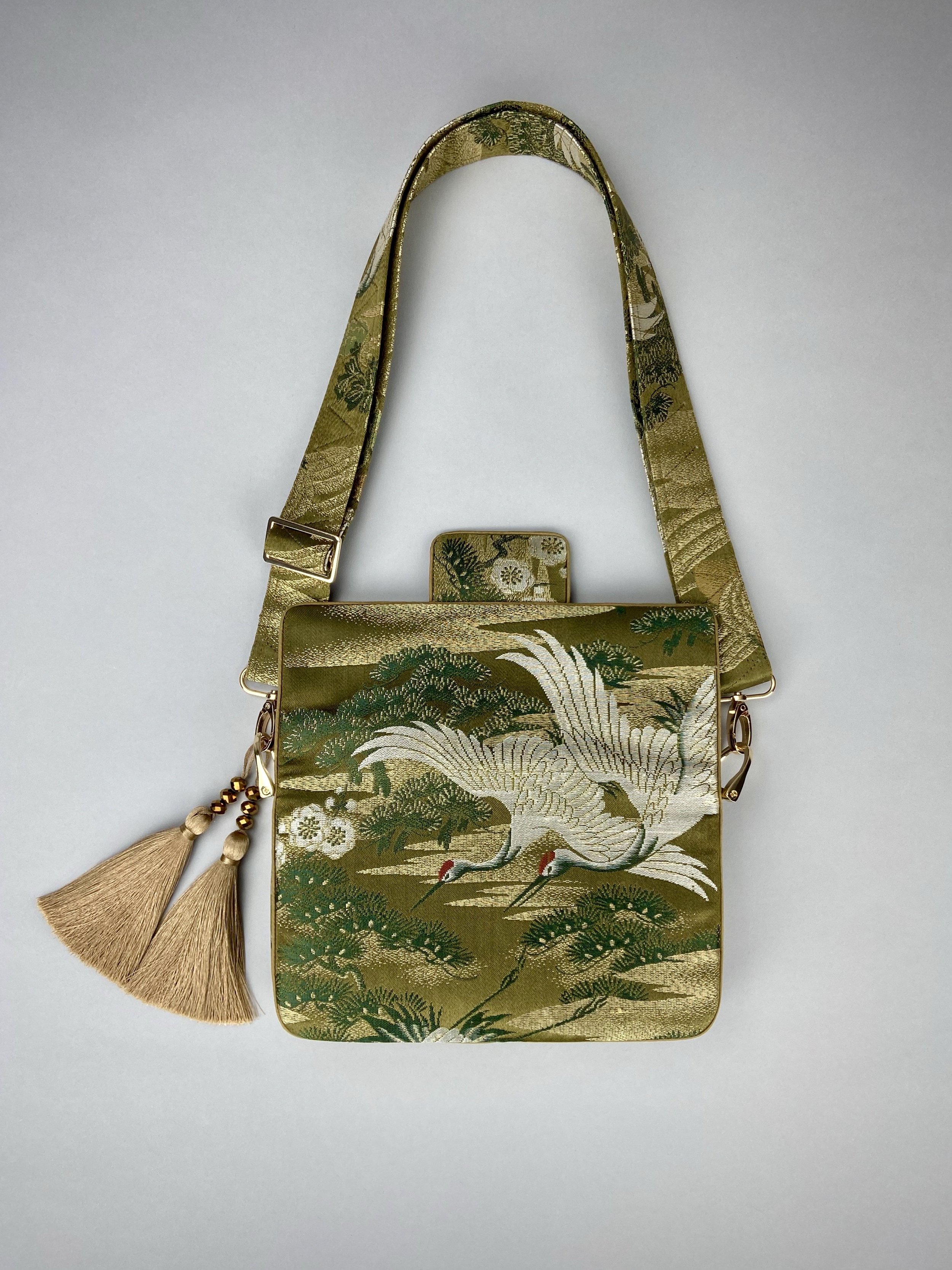 Unique Flying Crane baguette bag, handmade from vintage Japanese obi silk with gold hardware and matching silk tassel charm by Kirsty Chivers