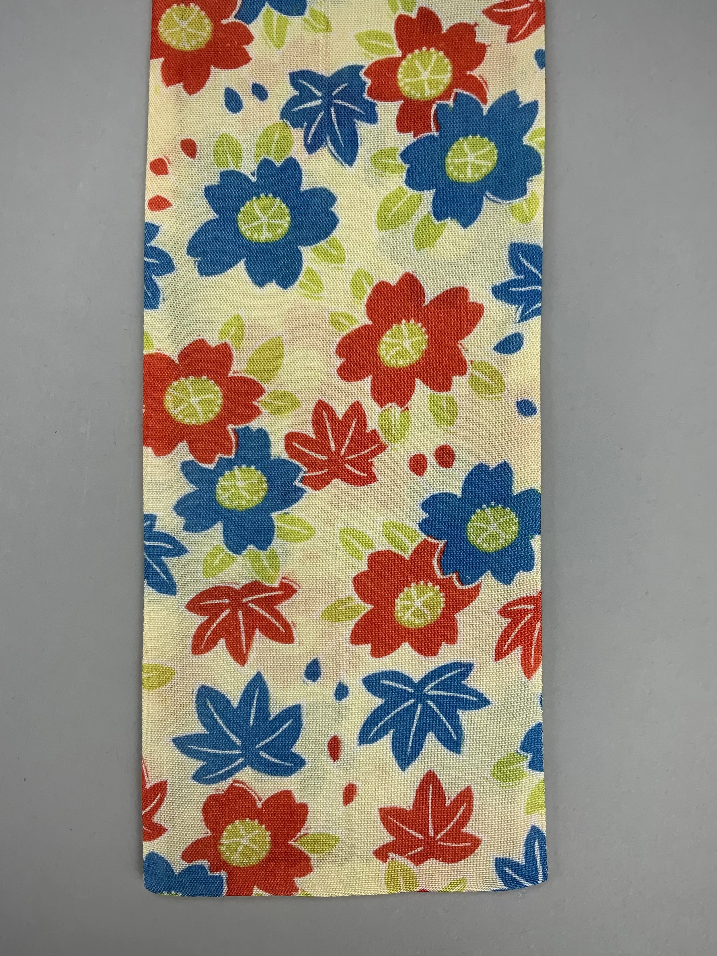 Closeup of butter yellow skinny scarf with Cherry blossom & Maple leaf print, handmade by Kirsty Chivers