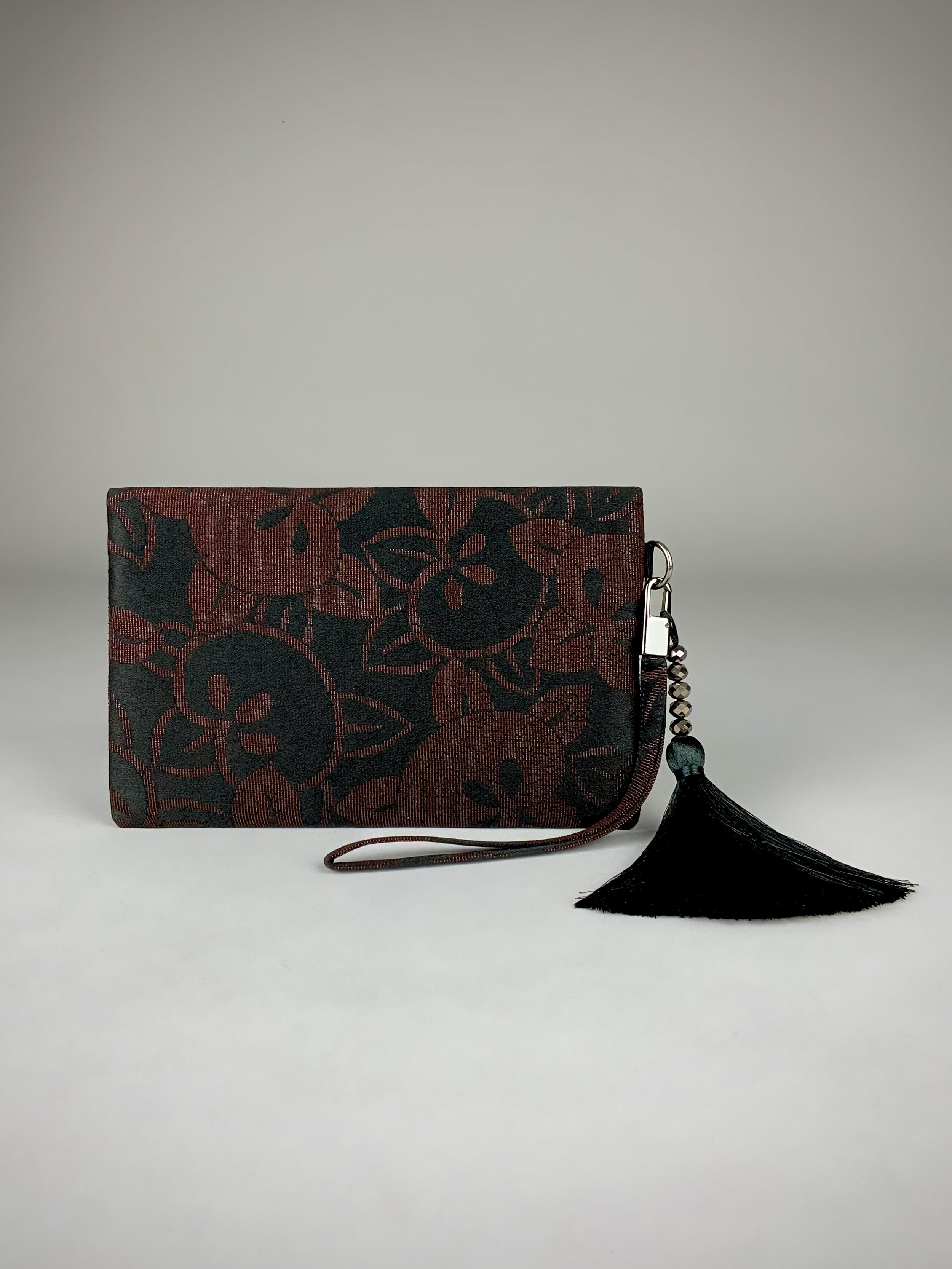 Back view of glittery black wristlet clutch purse with tassel, handmade from vintage Japanese kimono silk