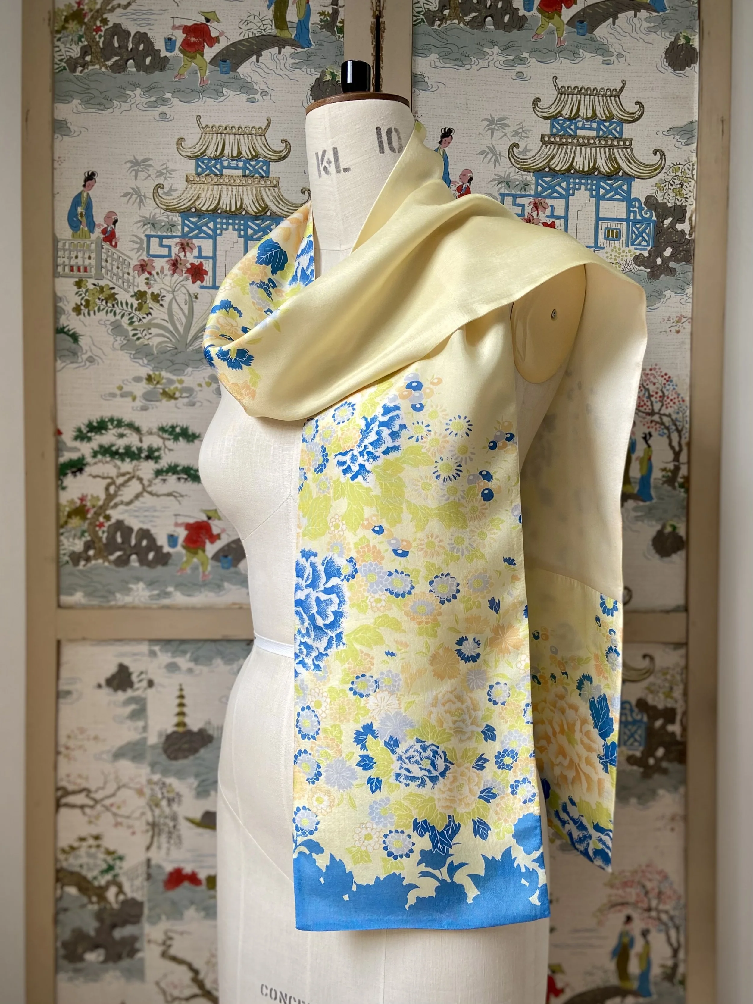 Yellow scarf with blossom print, presented on a dress stand, handmade from vintage kimono fabric and silk satin by Kirsty Chivers