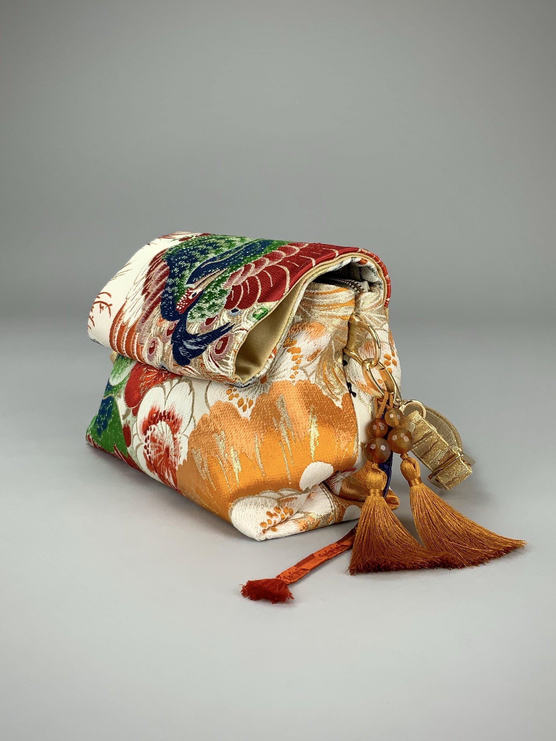 One-of-a-kind evening bag in vintage obi silk with peacock, pine motifs & gold accents