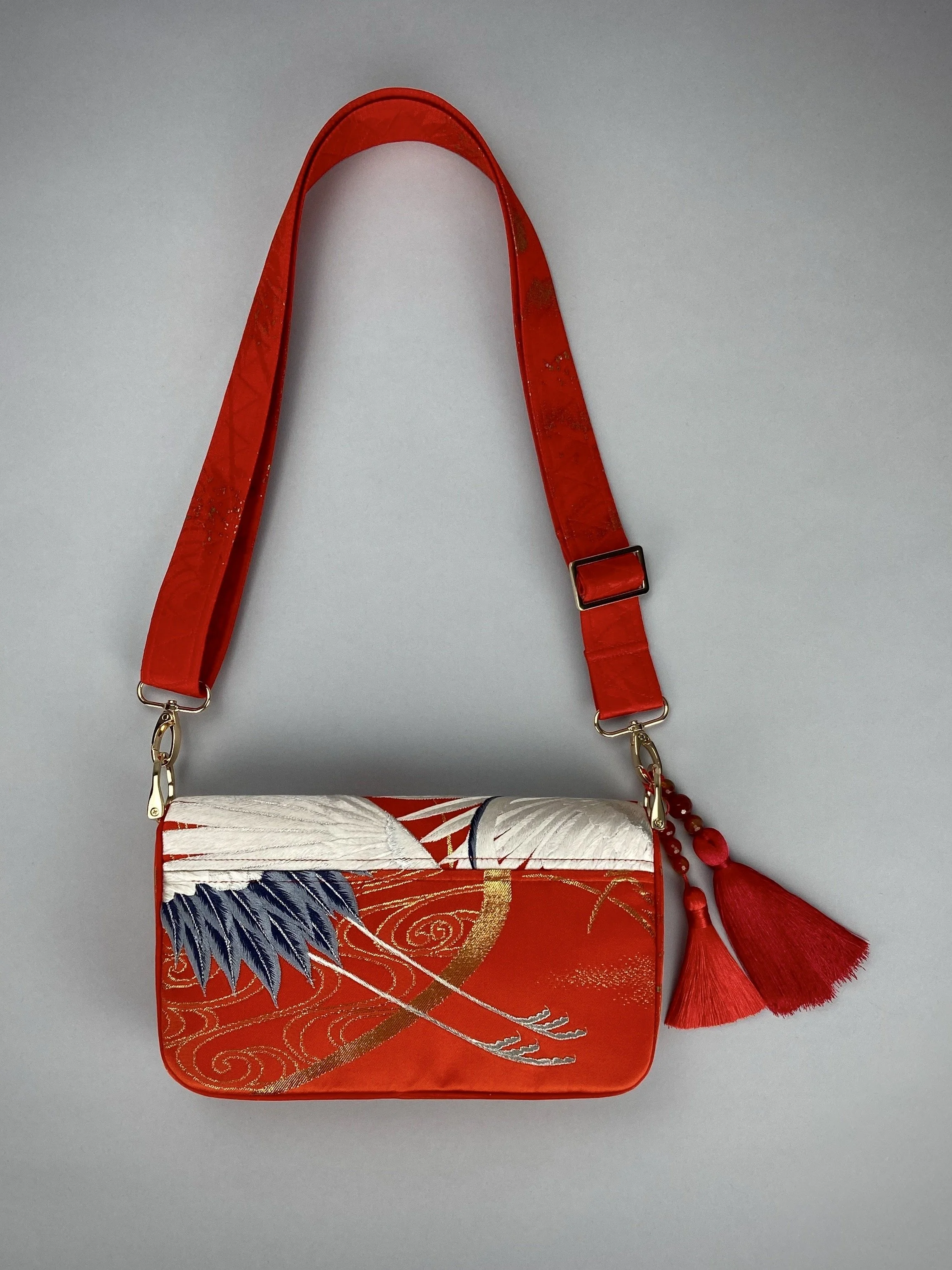 Vermillion Crane Feather baguette bag, made from vintage Japanese kimono silk, with gold hardware and Agate beaded tassel charms by Kirsty Chivers