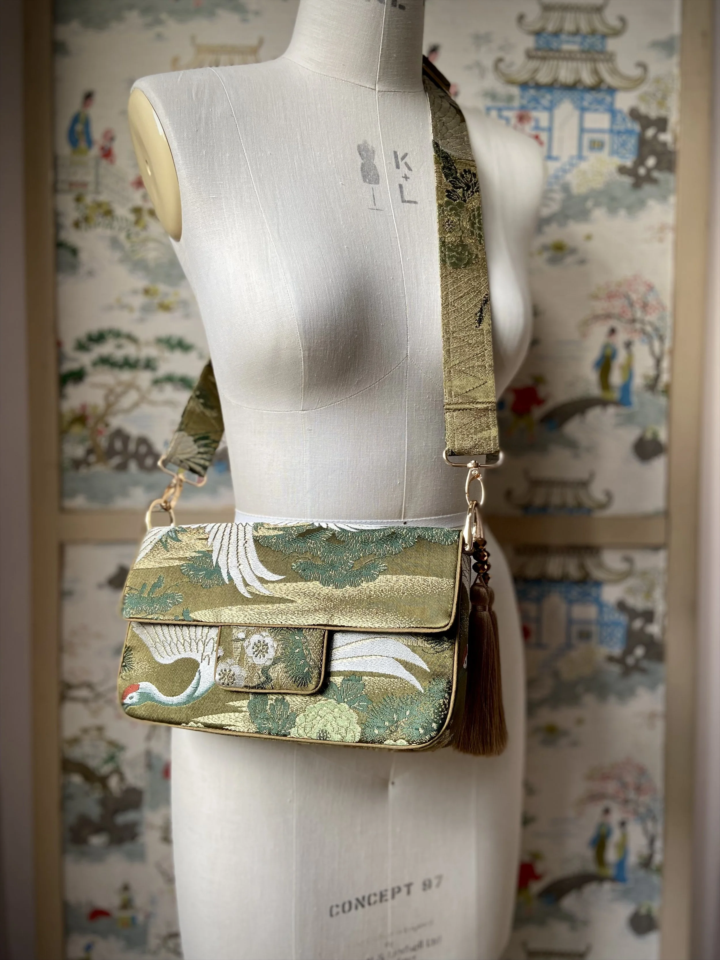 Unique Flying Crane baguette bag, handmade from vintage Japanese obi silk with gold hardware and matching silk tassel charm by Kirsty Chivers