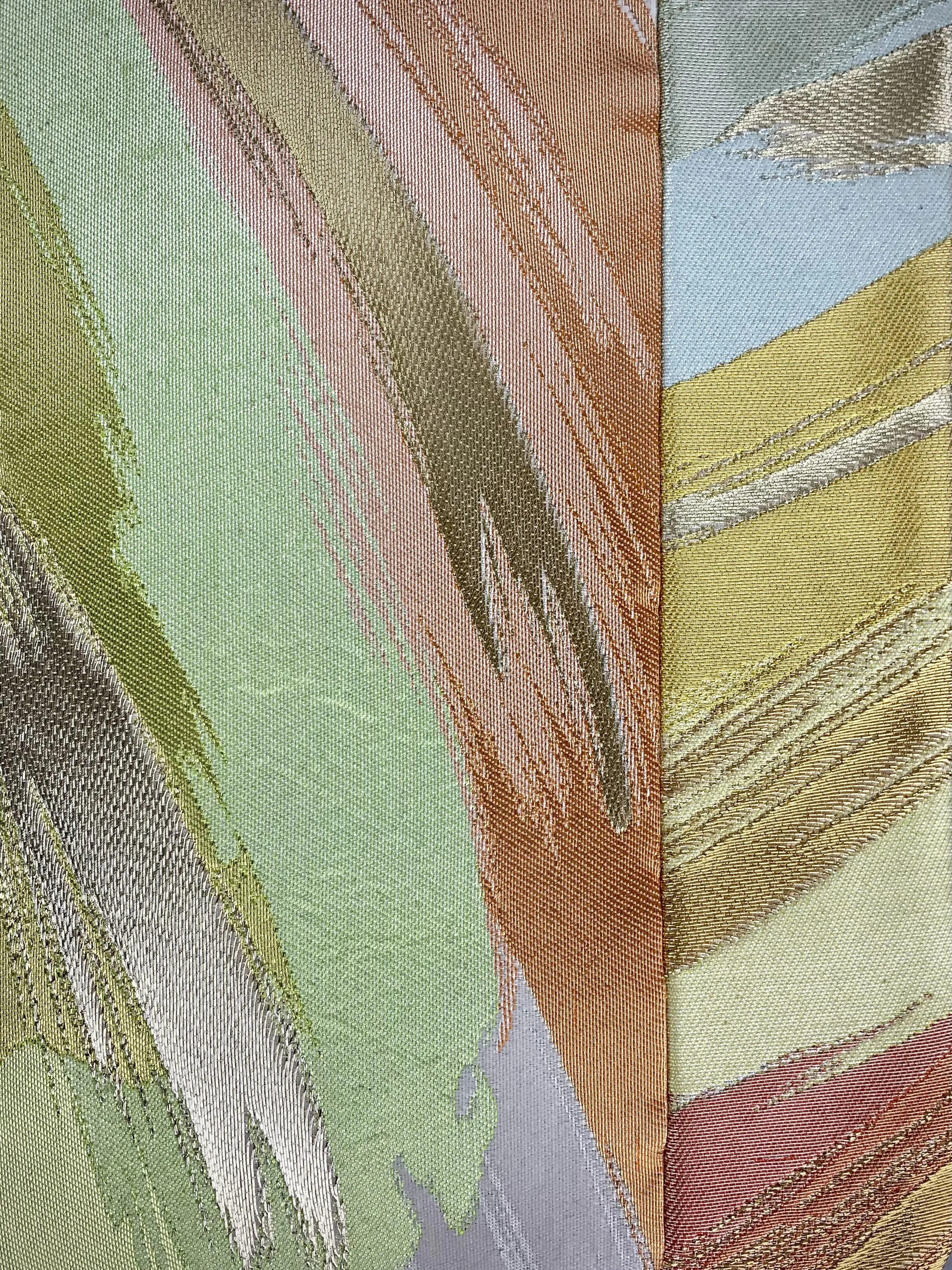 Closeup of wristlet purse made from repurposed vintage obi fabric with brushstroke pastel design and gold-silver threads