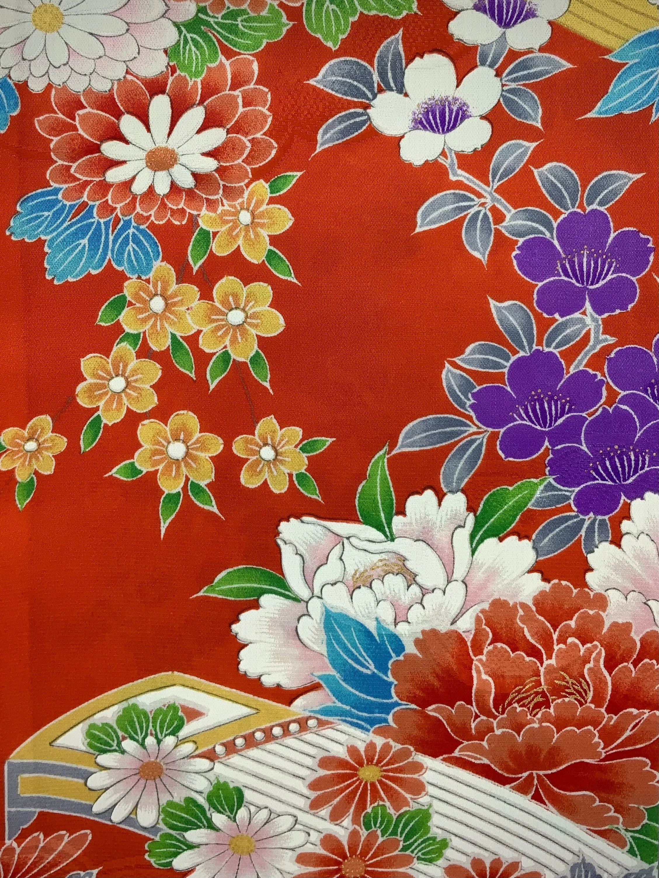 Closeup of orange scarf with blossom print made from rinzu kimono silk by Kirsty Chivers