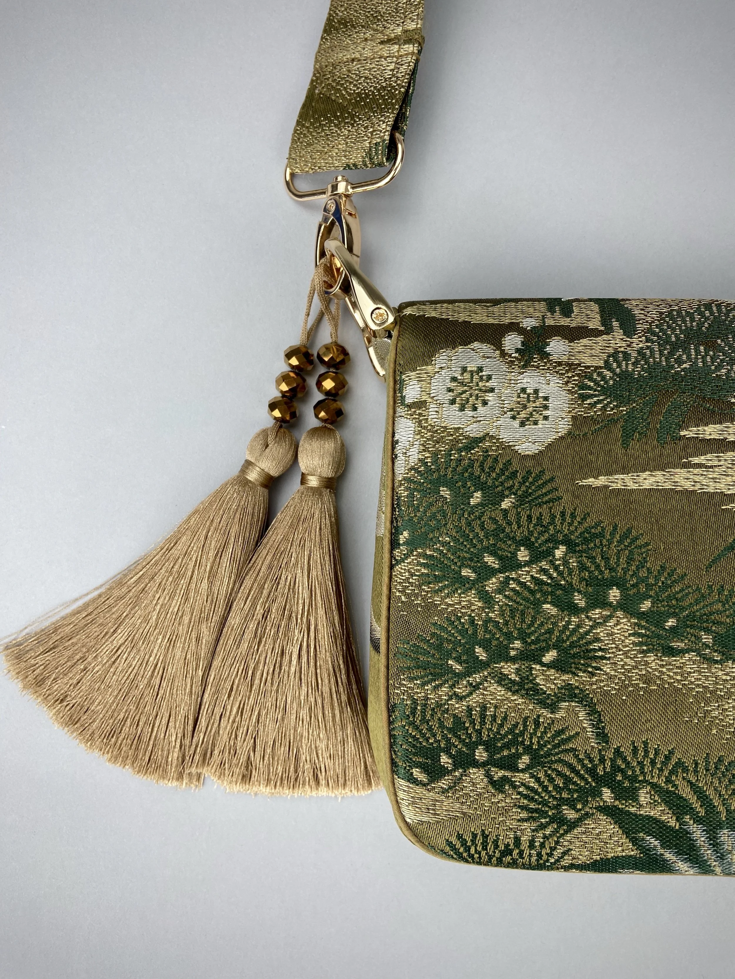 Unique Flying Crane baguette bag, handmade from vintage Japanese obi silk with gold hardware and matching silk tassel charm by Kirsty Chivers