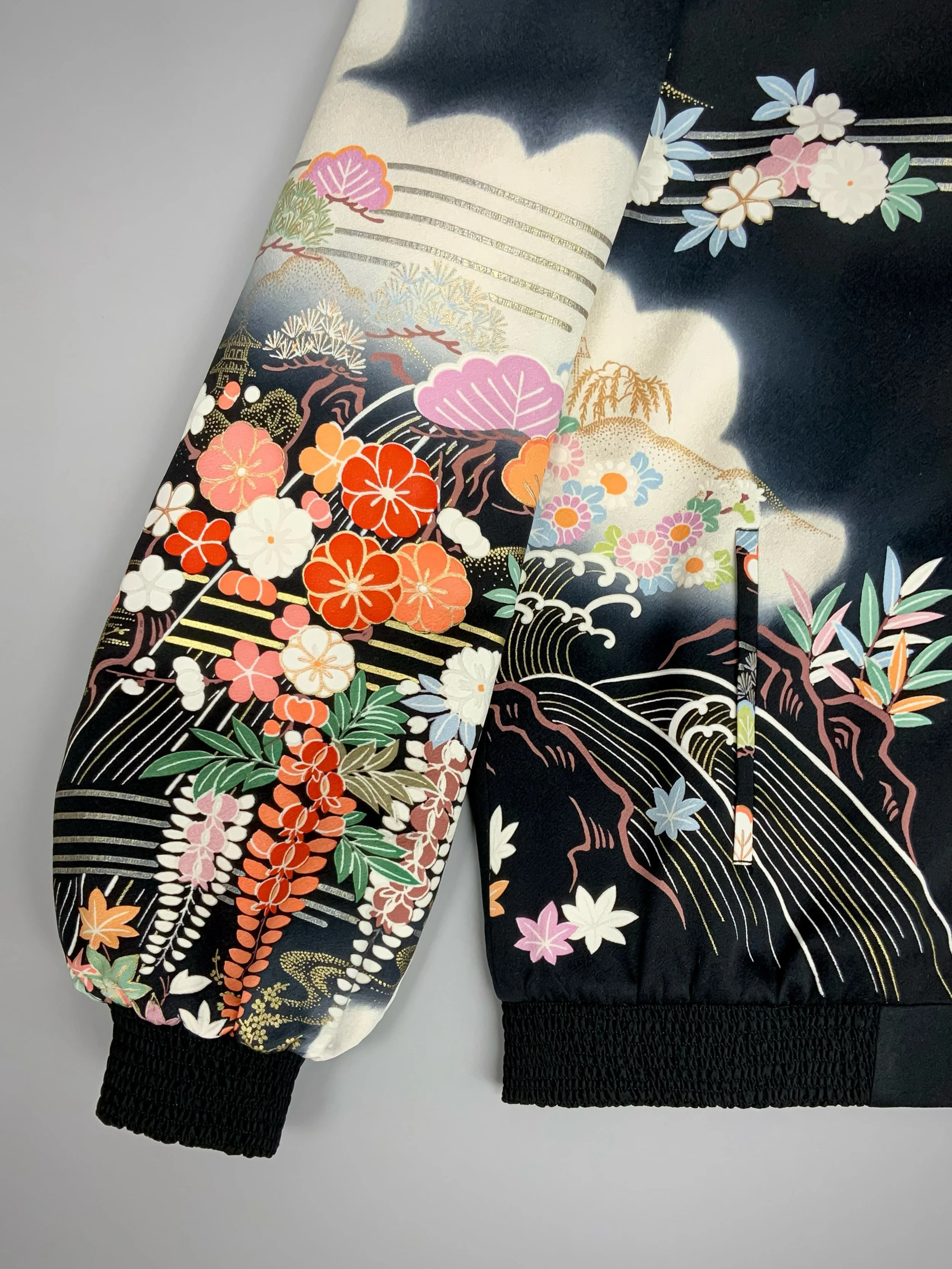 Closeup of unique bomber jacket with printed design, handmade with vintage Japanese Furisode kimono silk