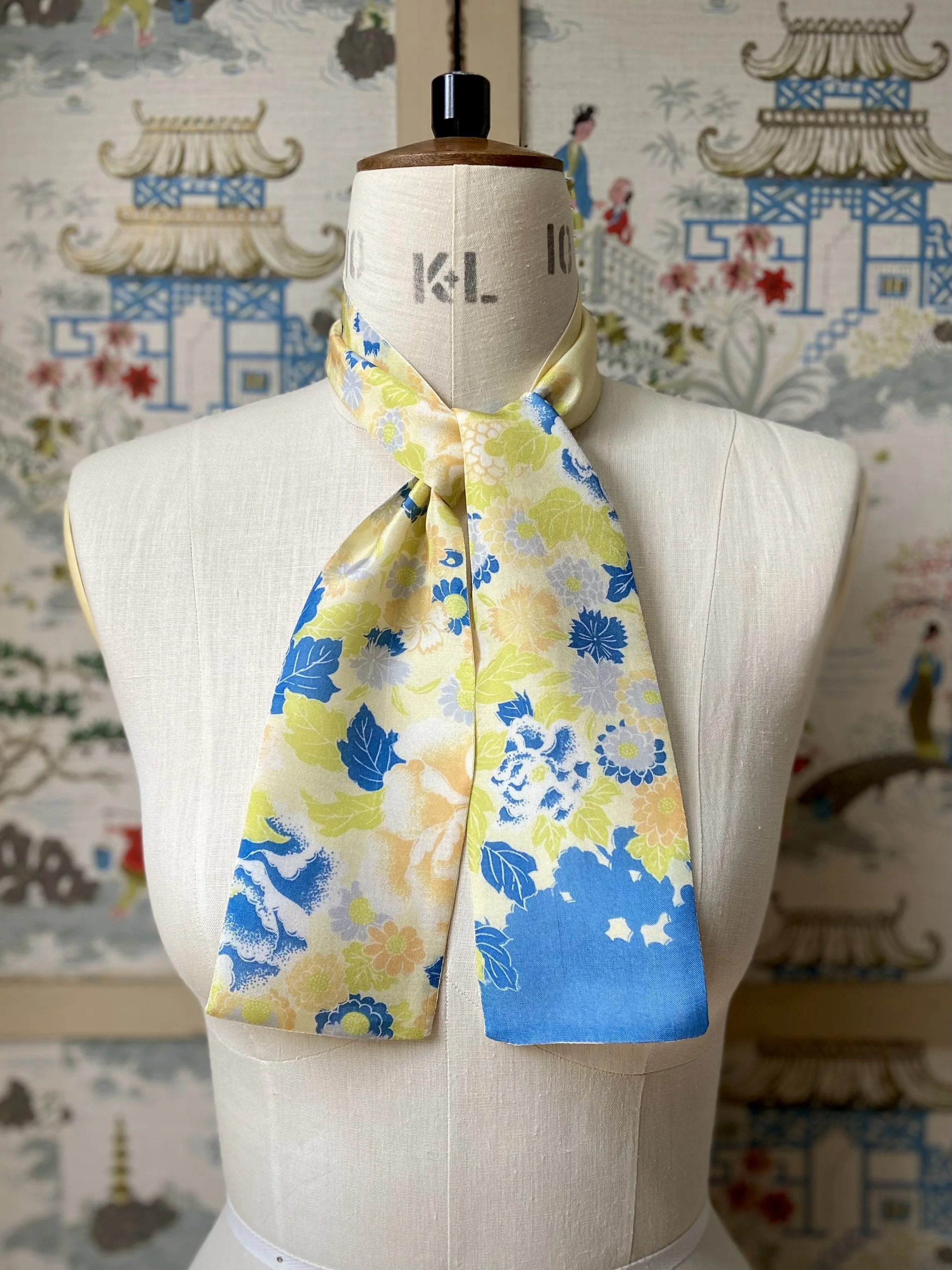 Pale yellow skinny scarf, presented on a dress stand, with blossom print handmade from vintage kimono fabric by Kirsty Chivers