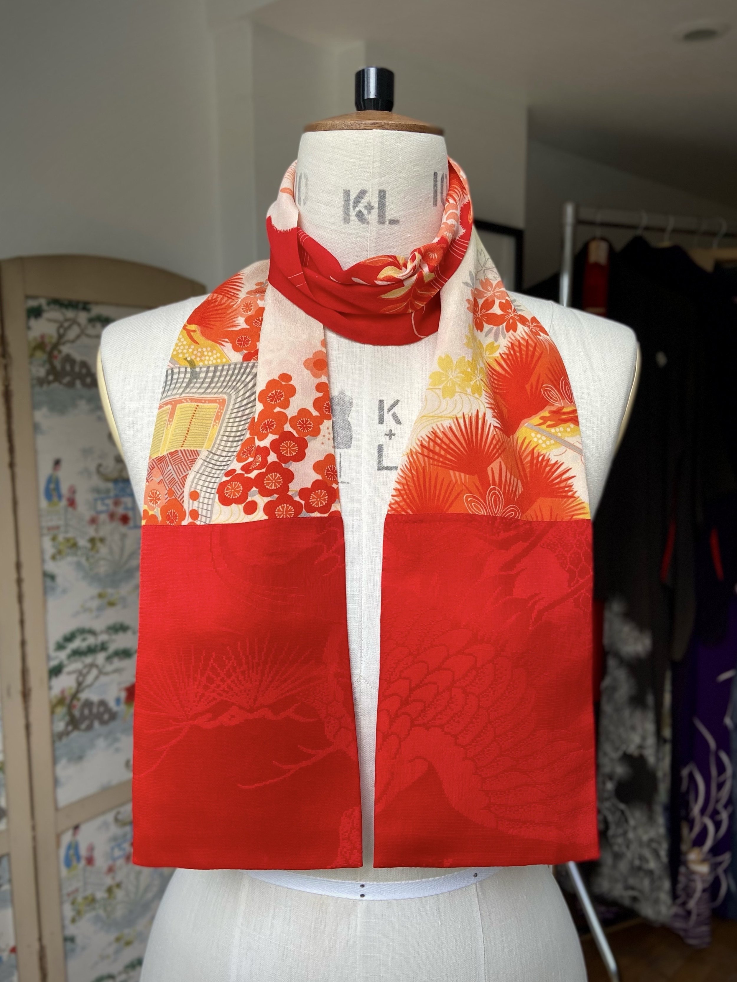 Bright red and yellow scarf presented on a dress stand, with printed blossom design, handmade from repurposed Japanese kimono crepe silk by Kirsty Chivers