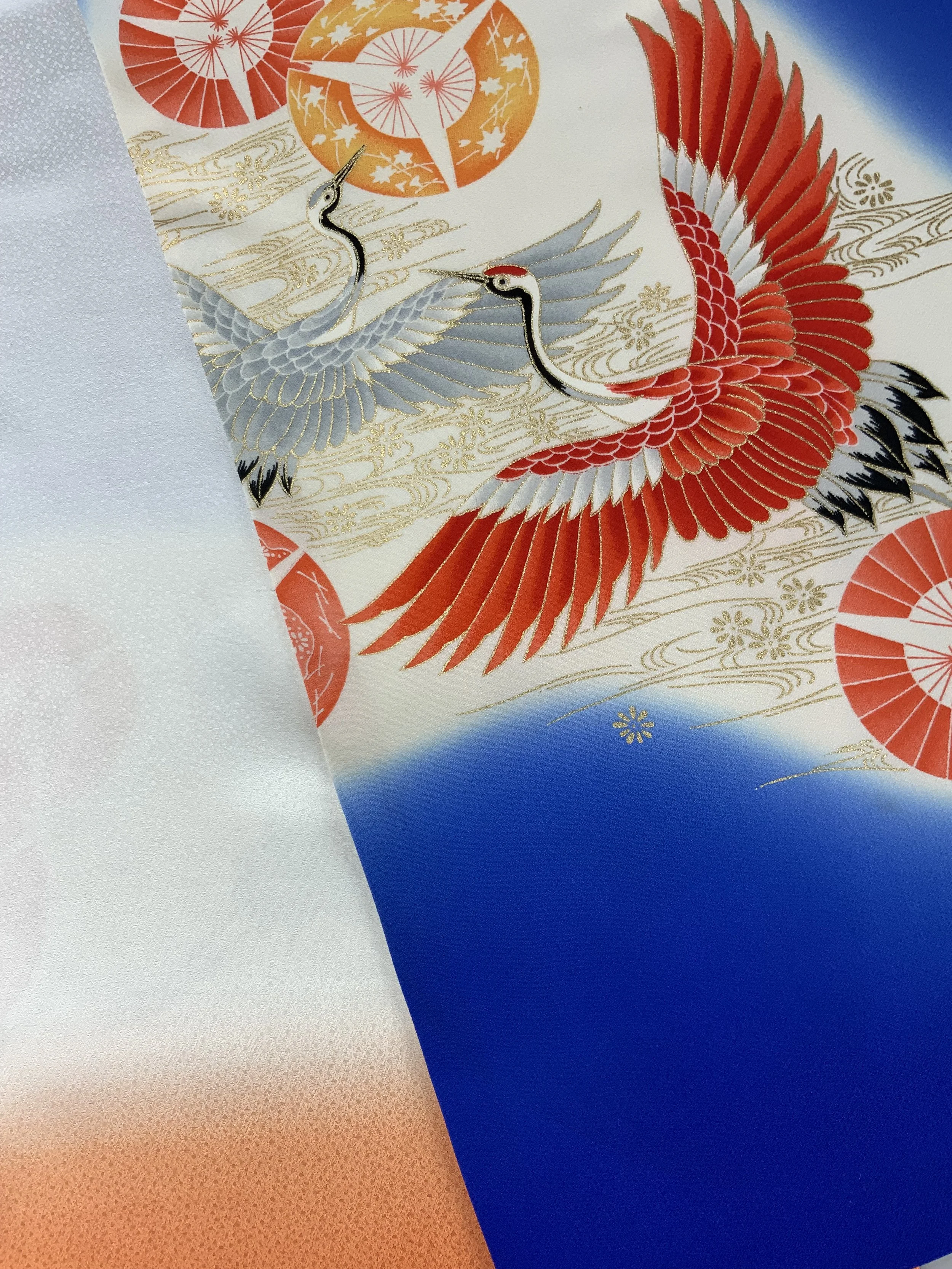 Closeup of electric blue silk scarf with Flying Crane print handmade by Kirsty Chivers