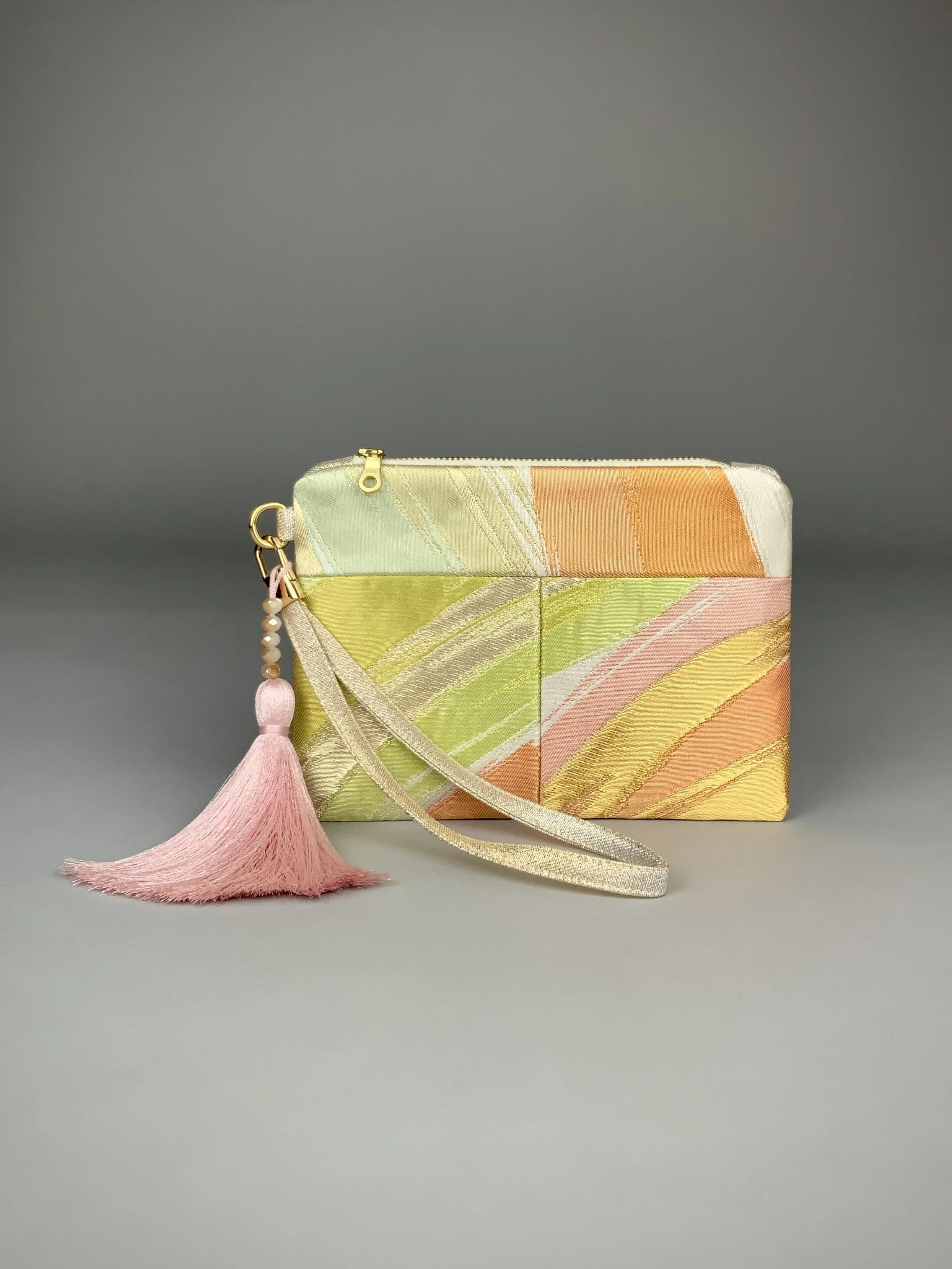 Wristlet purse made from repurposed vintage obi fabric with brushstroke pastel design and gold-silver threads