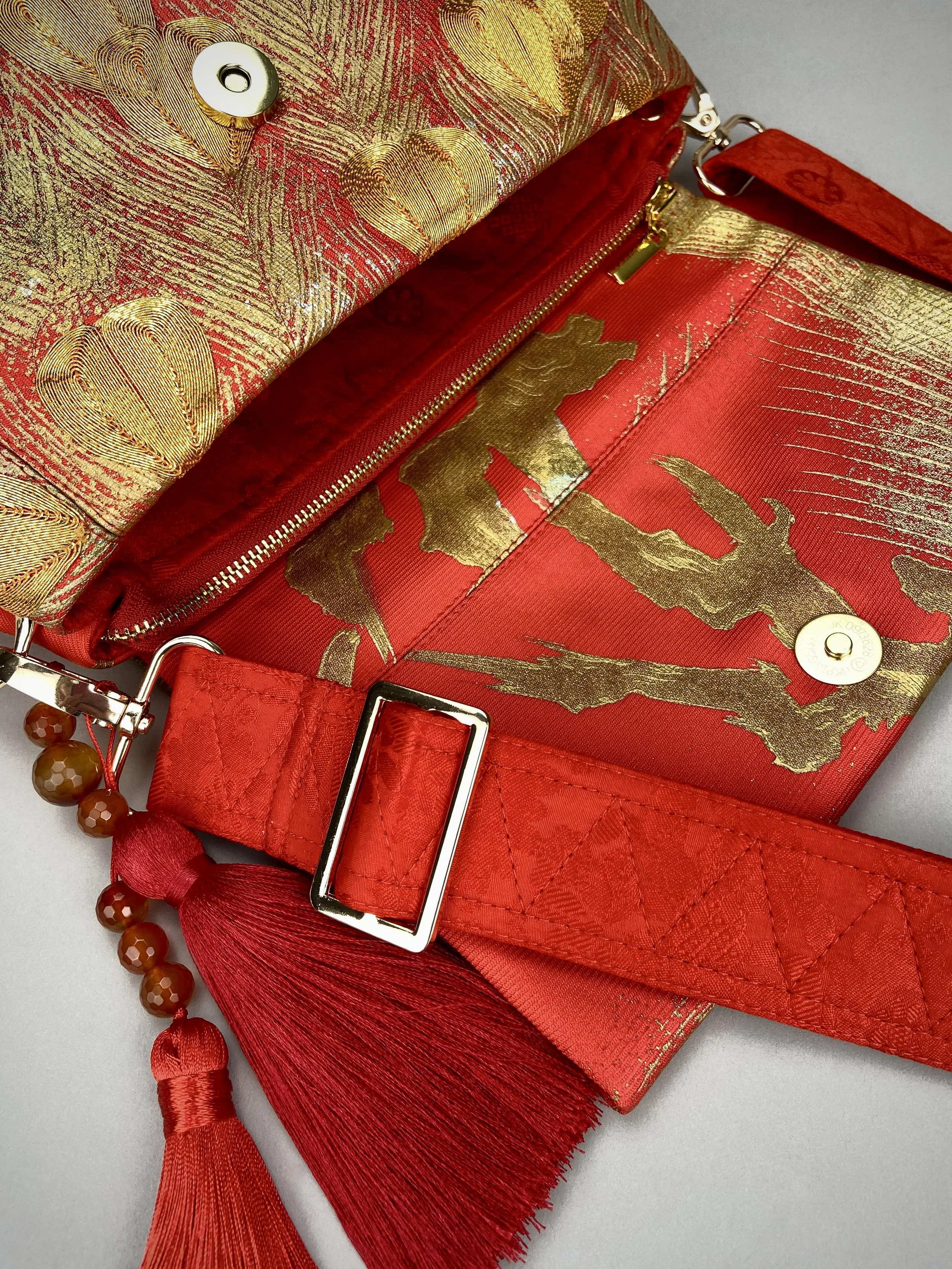 Vermillion red vintage kimono silk evening bag with gold Peacock feather design by Kirsty Chivers
