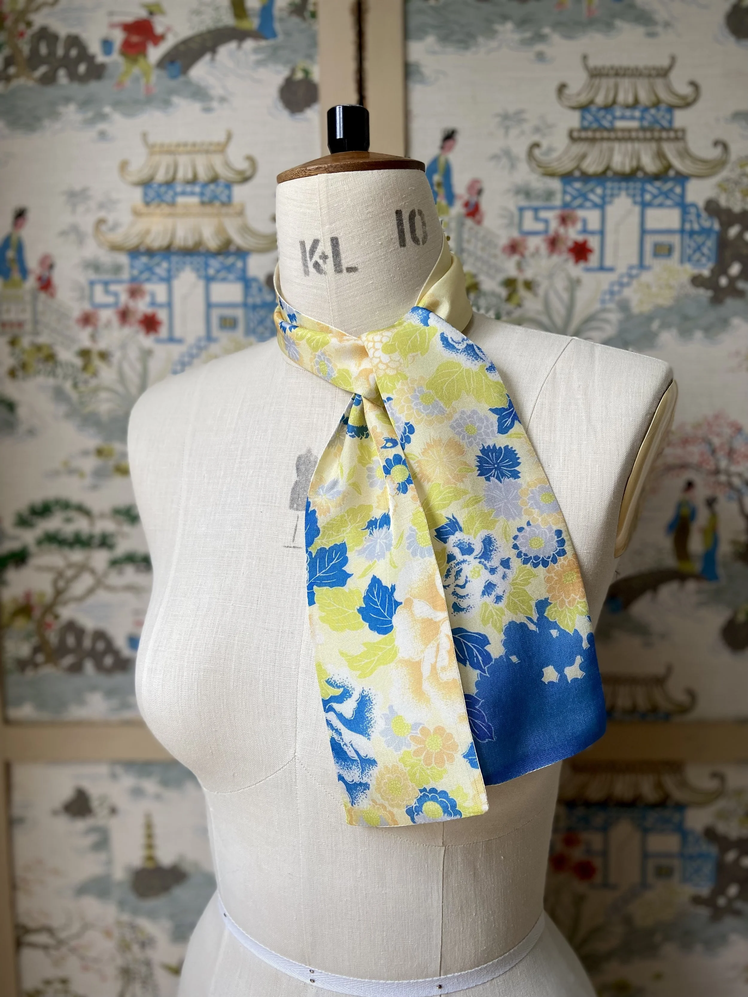 Pale yellow skinny scarf, presented on a dress stand, with blossom print handmade from vintage kimono fabric by Kirsty Chivers
