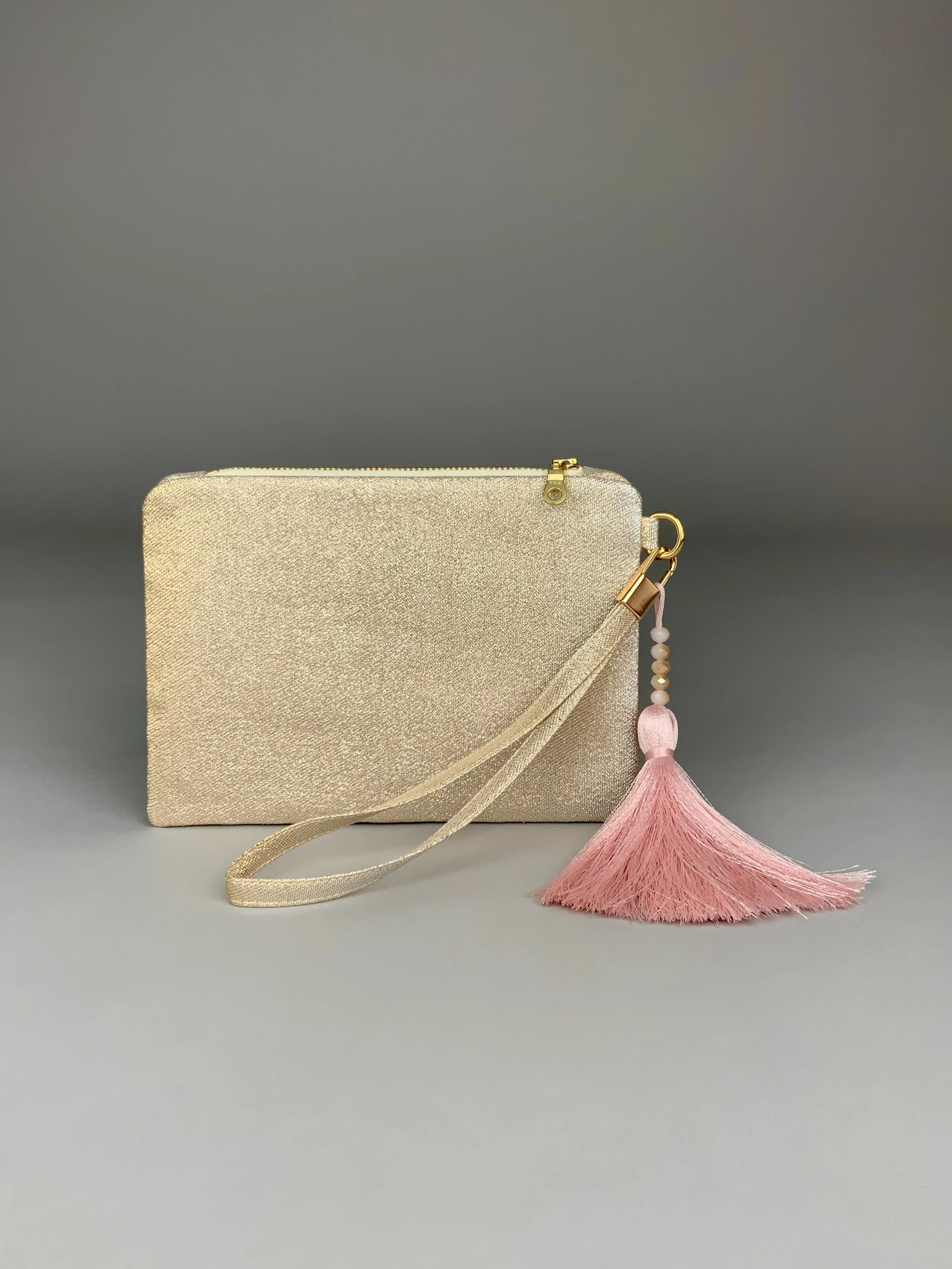 Wristlet purse made from repurposed vintage obi fabric with brushstroke pastel design and gold-silver threads