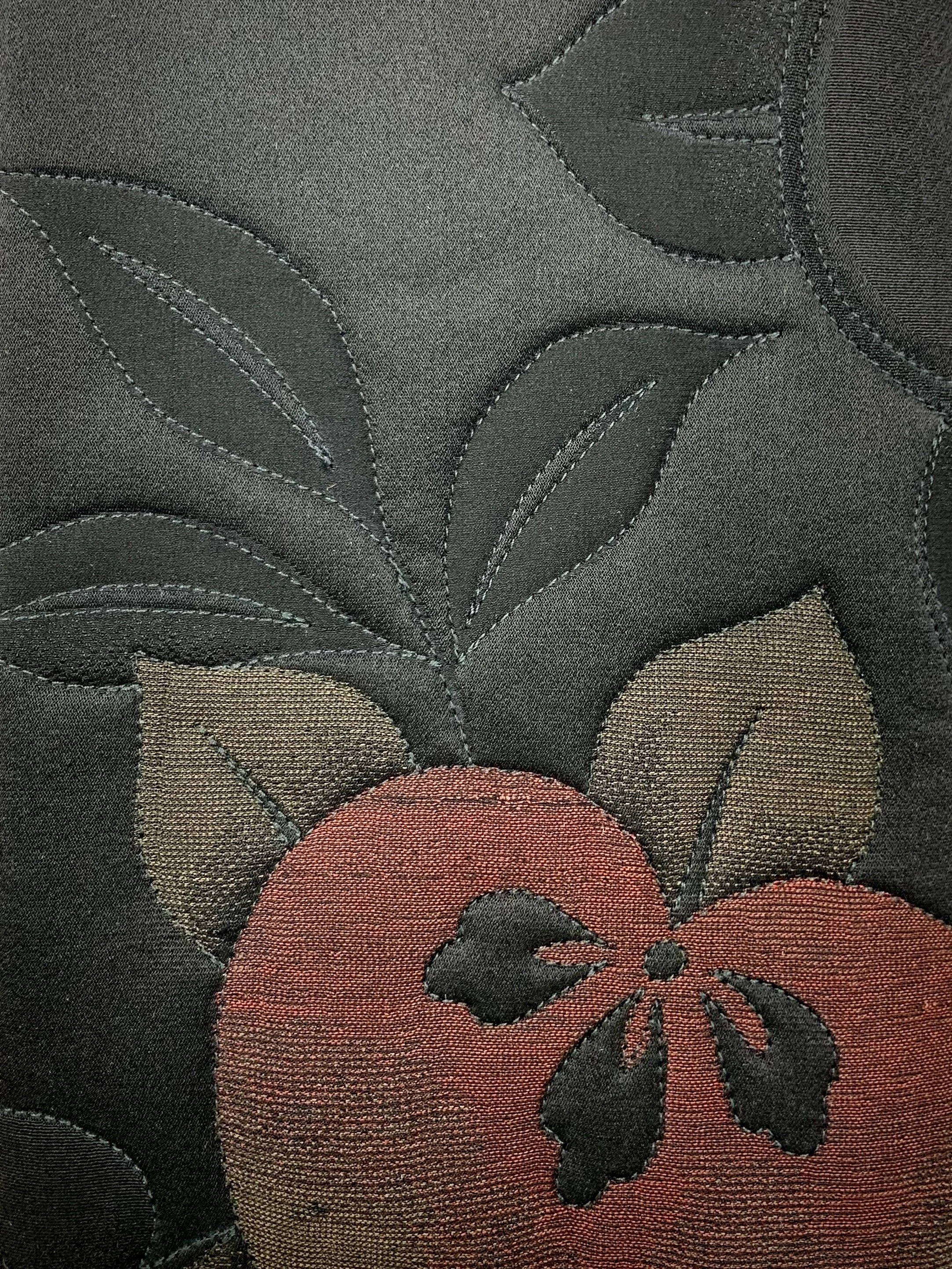 Closeup of black quilted clutch purse with tassel & Carnelian beads, made from vintage Japanese kimono silk