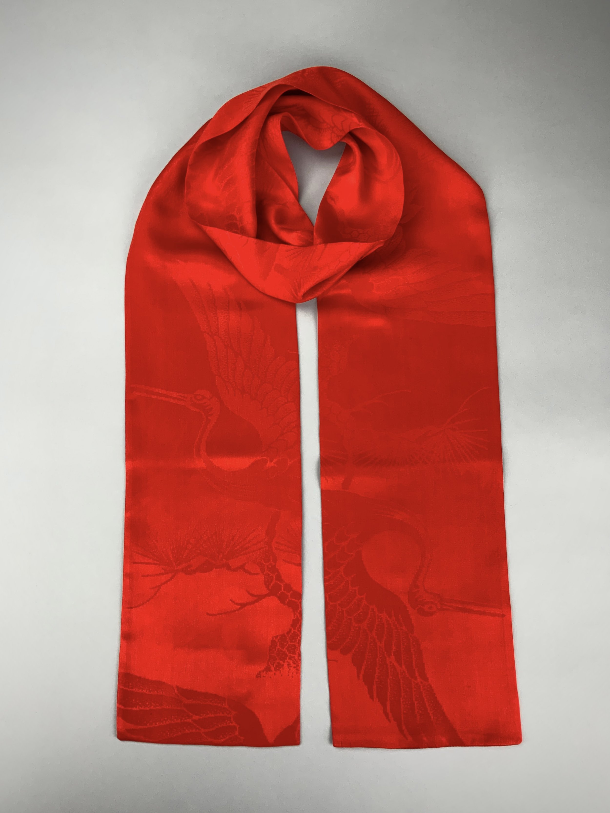 Flatlay of a vibrant vermillion red silk scarf crafted from kimono silk by Kirsty Chivers Handmade