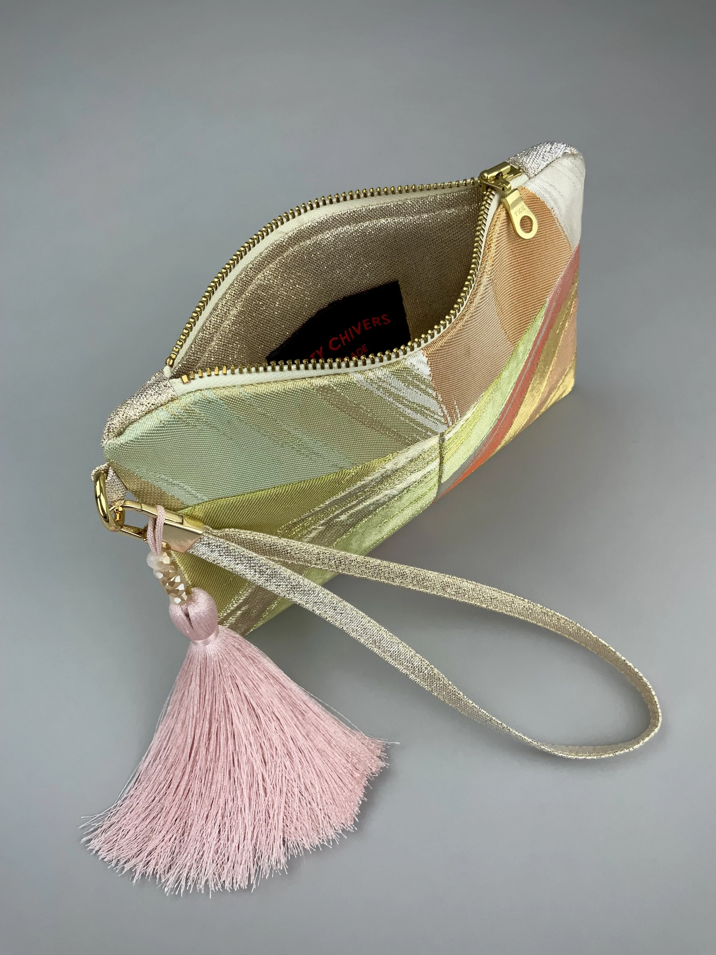 Inside view of wristlet purse made from repurposed vintage obi fabric with brushstroke pastel design and gold-silver threads