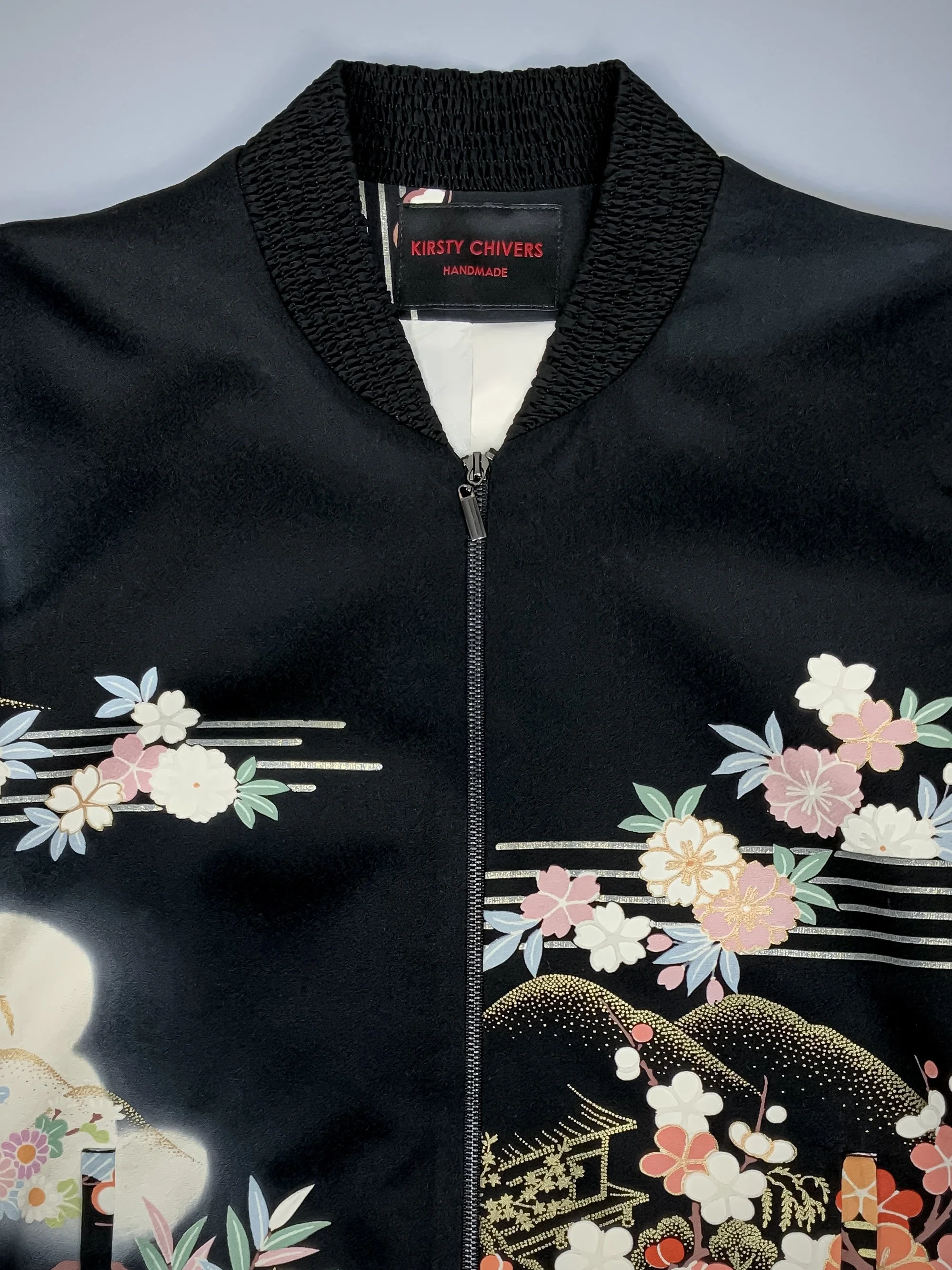Closeup of unique bomber jacket with printed design, handmade with vintage Japanese Furisode kimono silk