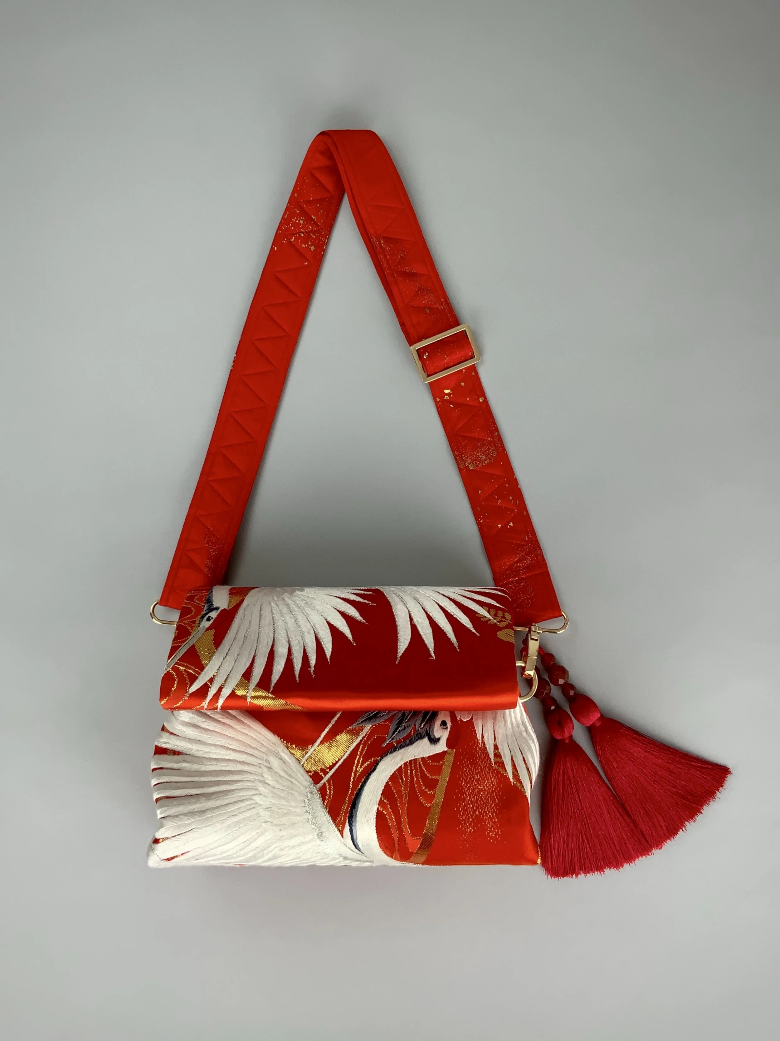Vermillion red evening bag with embroidered crane design, handmade from vintage kimono silk by Kirsty Chivers
