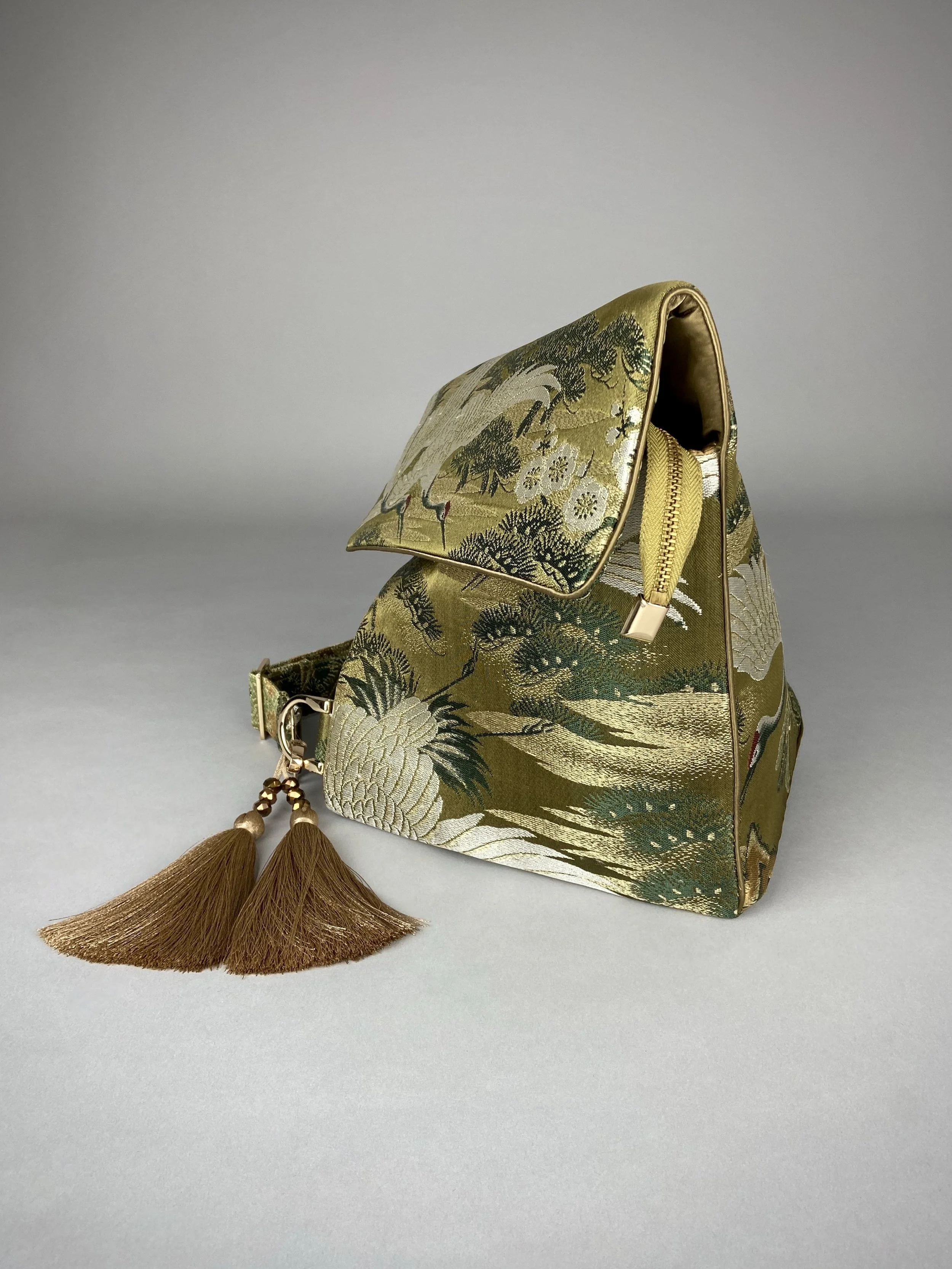 Green and gold vintage obi silk shoulder bag with crane, pine and chrysanthemum design, gold hardware and matching fabric tassel charm by Kirsty Chivers