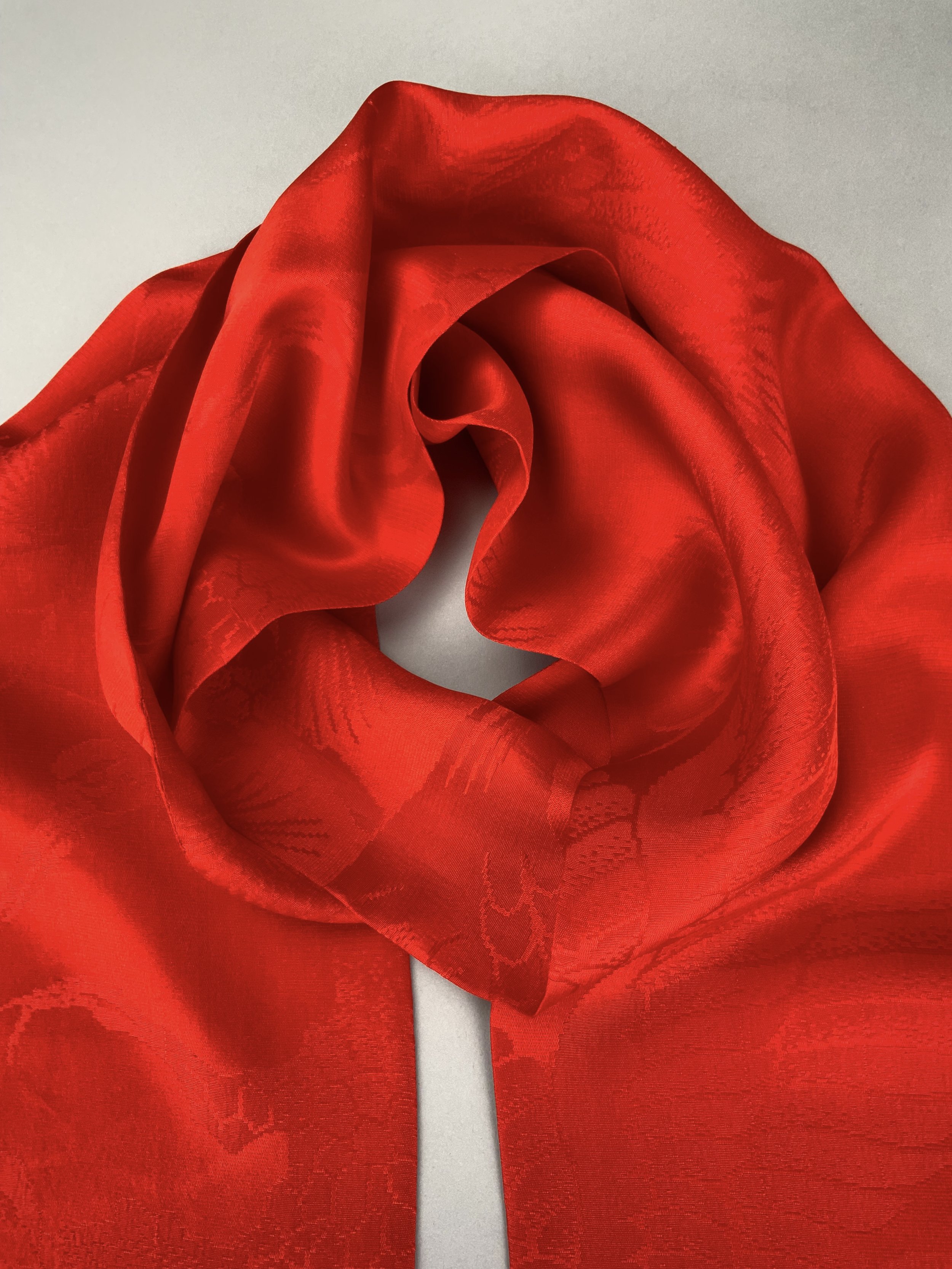 Flatlay of a vibrant vermillion red silk scarf crafted from kimono silk by Kirsty Chivers Handmade