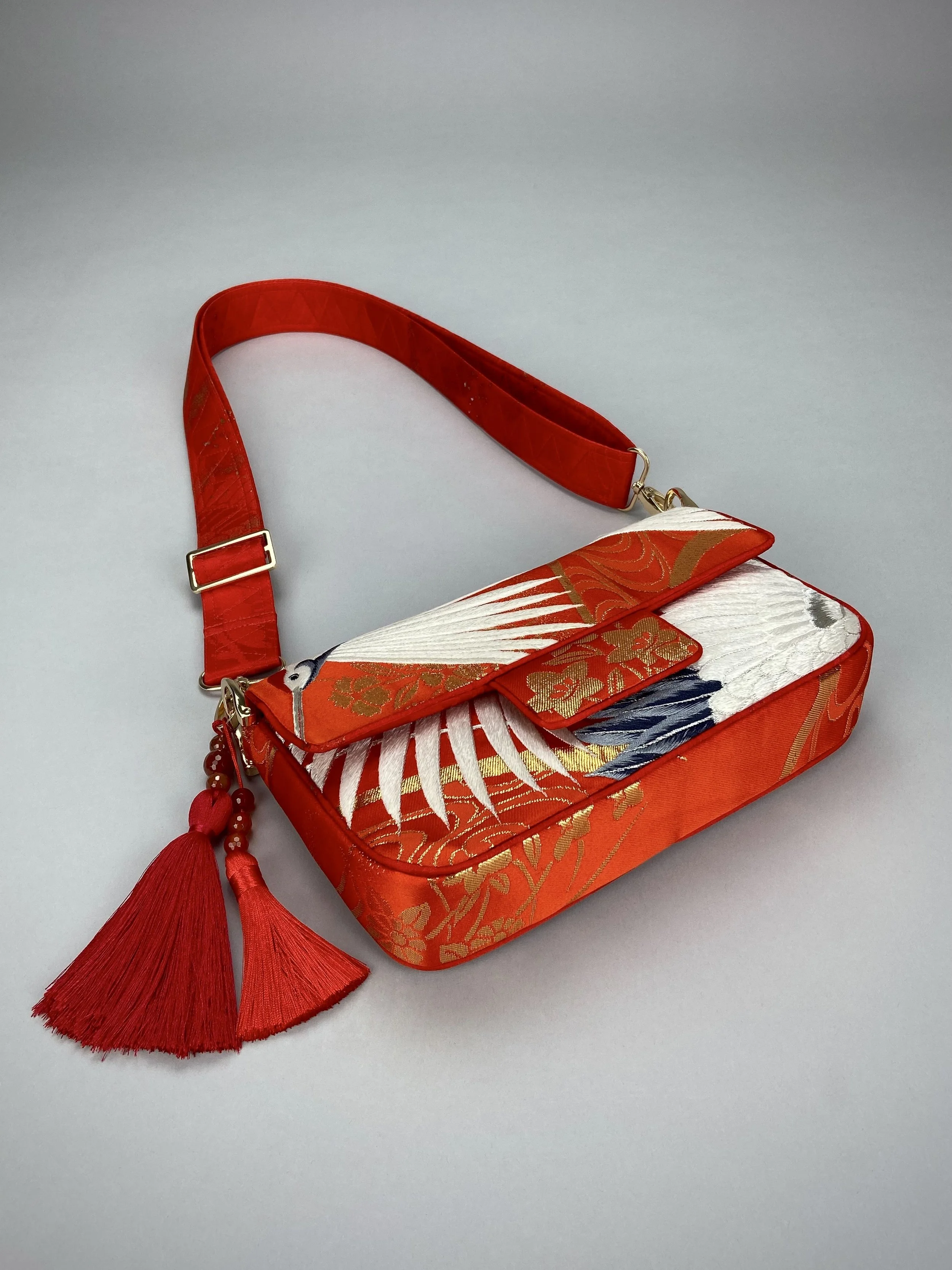 Vermillion Crane Feather baguette bag, made from vintage Japanese kimono silk, with gold hardware and Agate beaded tassel charms by Kirsty Chivers