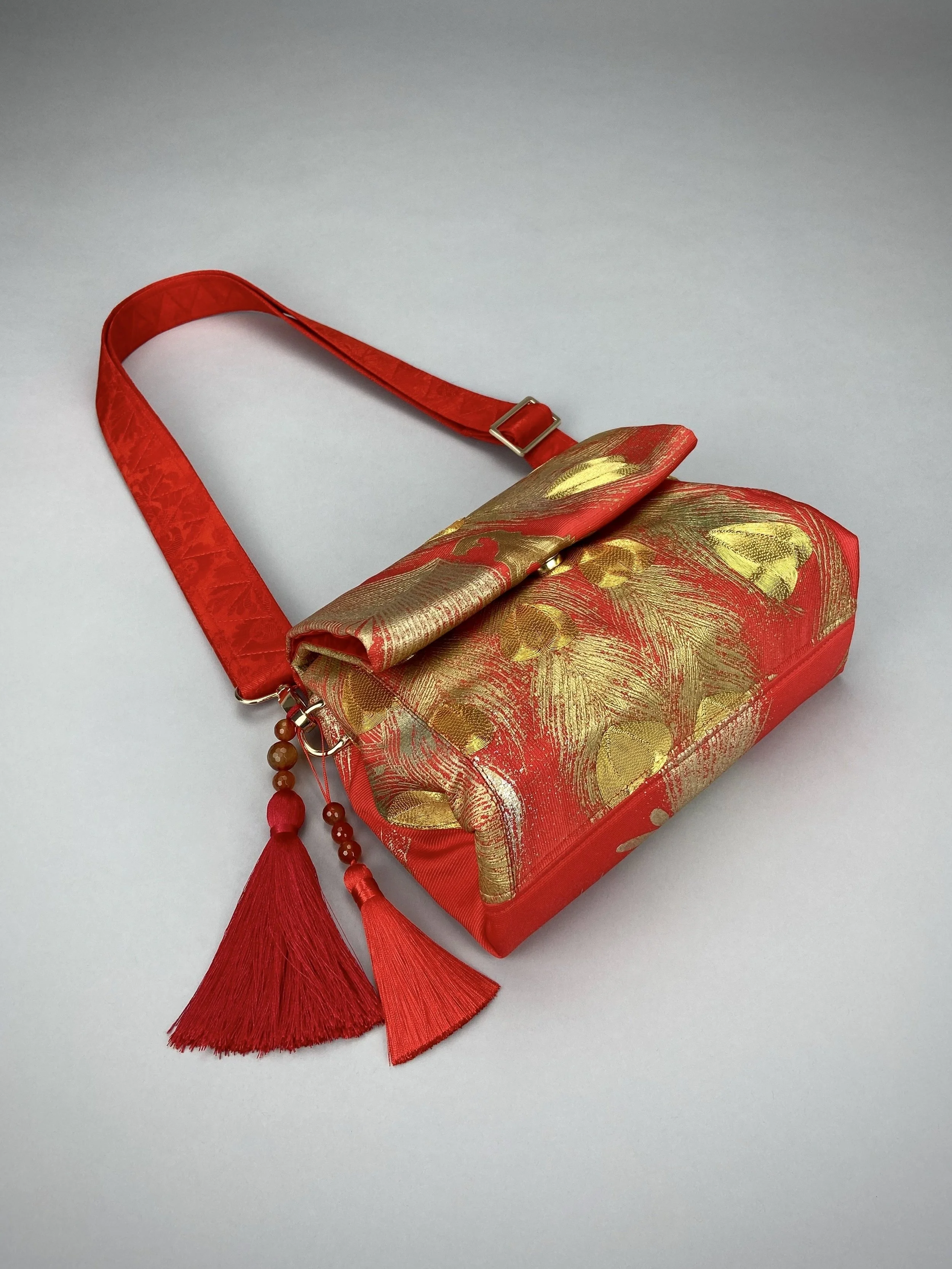 Vermillion red vintage kimono silk evening bag with gold Peacock feather design by Kirsty Chivers