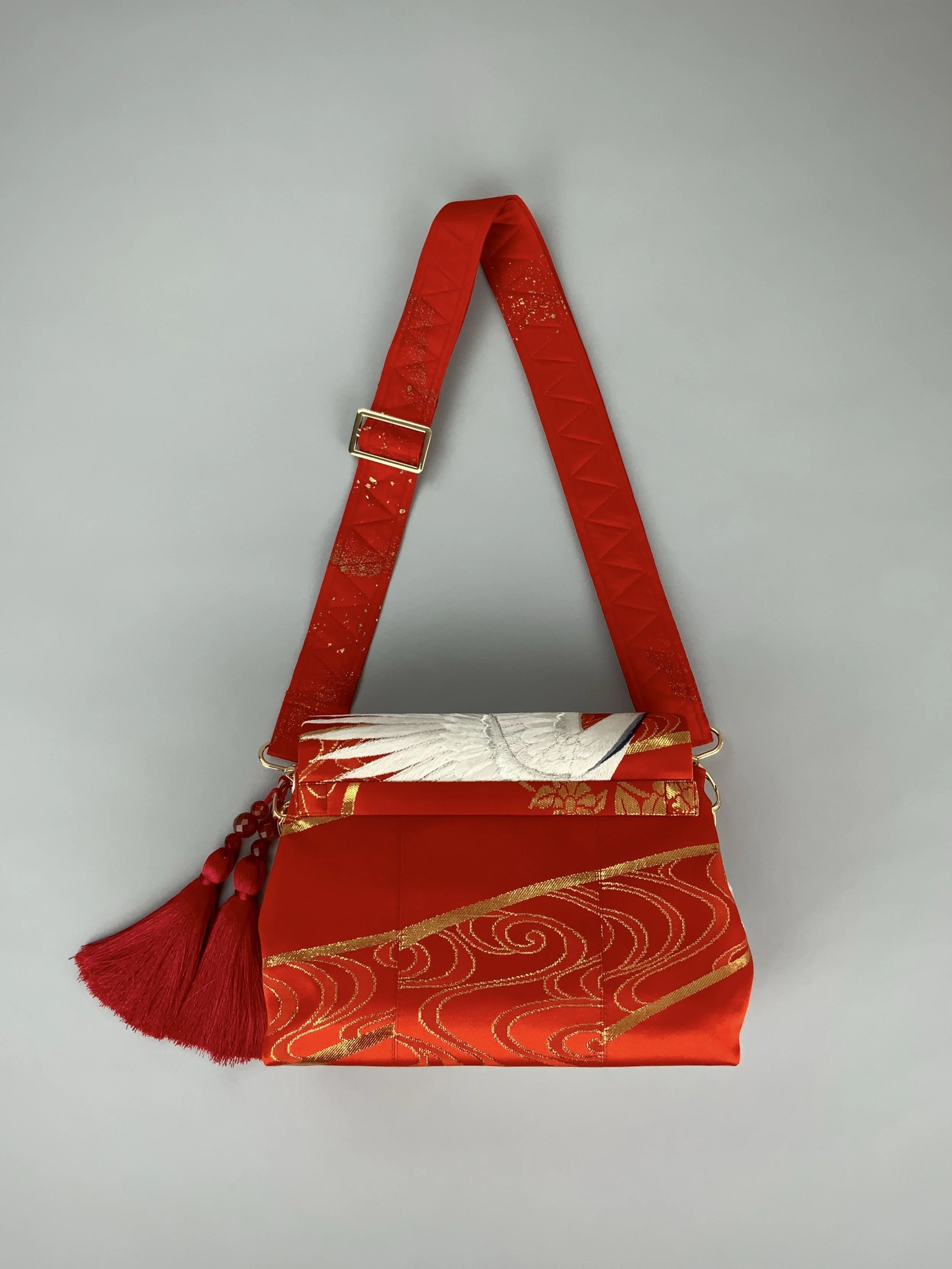 Vermillion red evening bag with embroidered crane design, handmade from vintage kimono silk by Kirsty Chivers
