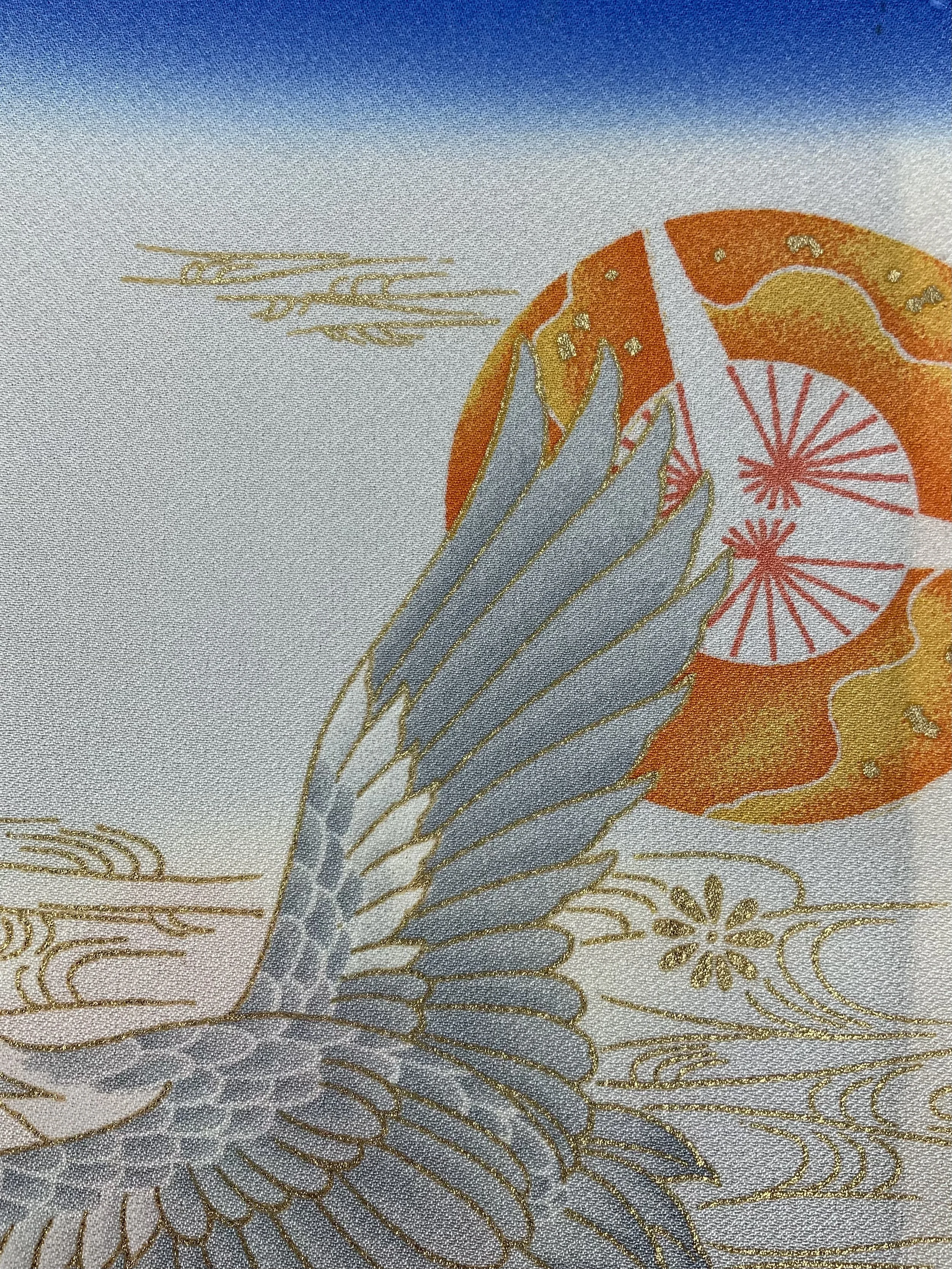 Closeup of blue silk scarf with printed Flying Crane design handmade by Kirsty Chivers