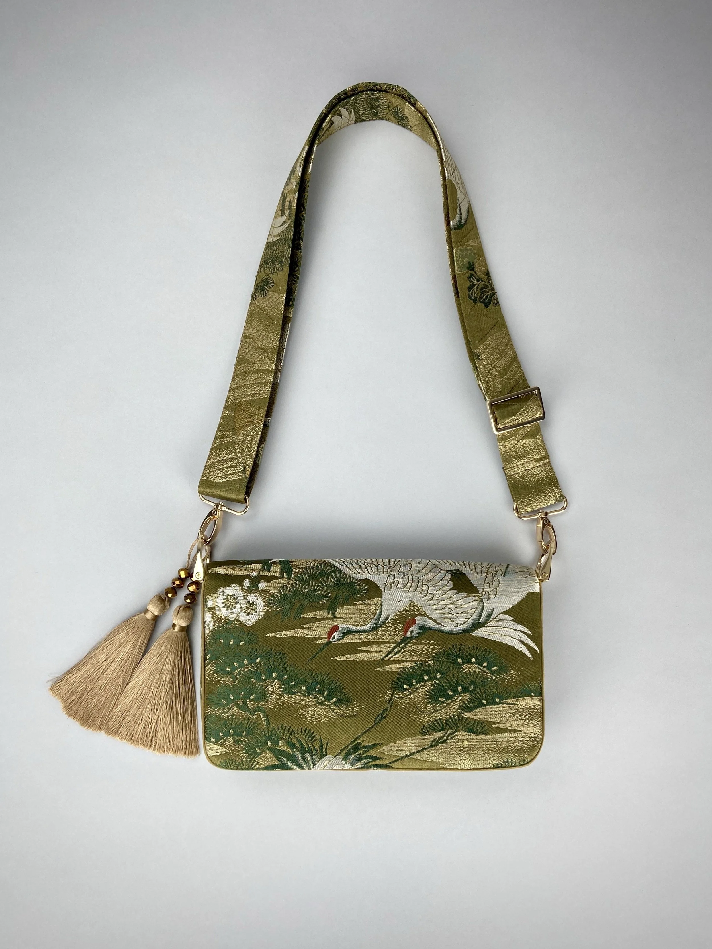 Unique Flying Crane baguette bag, handmade from vintage Japanese obi silk with gold hardware and matching silk tassel charm by Kirsty Chivers