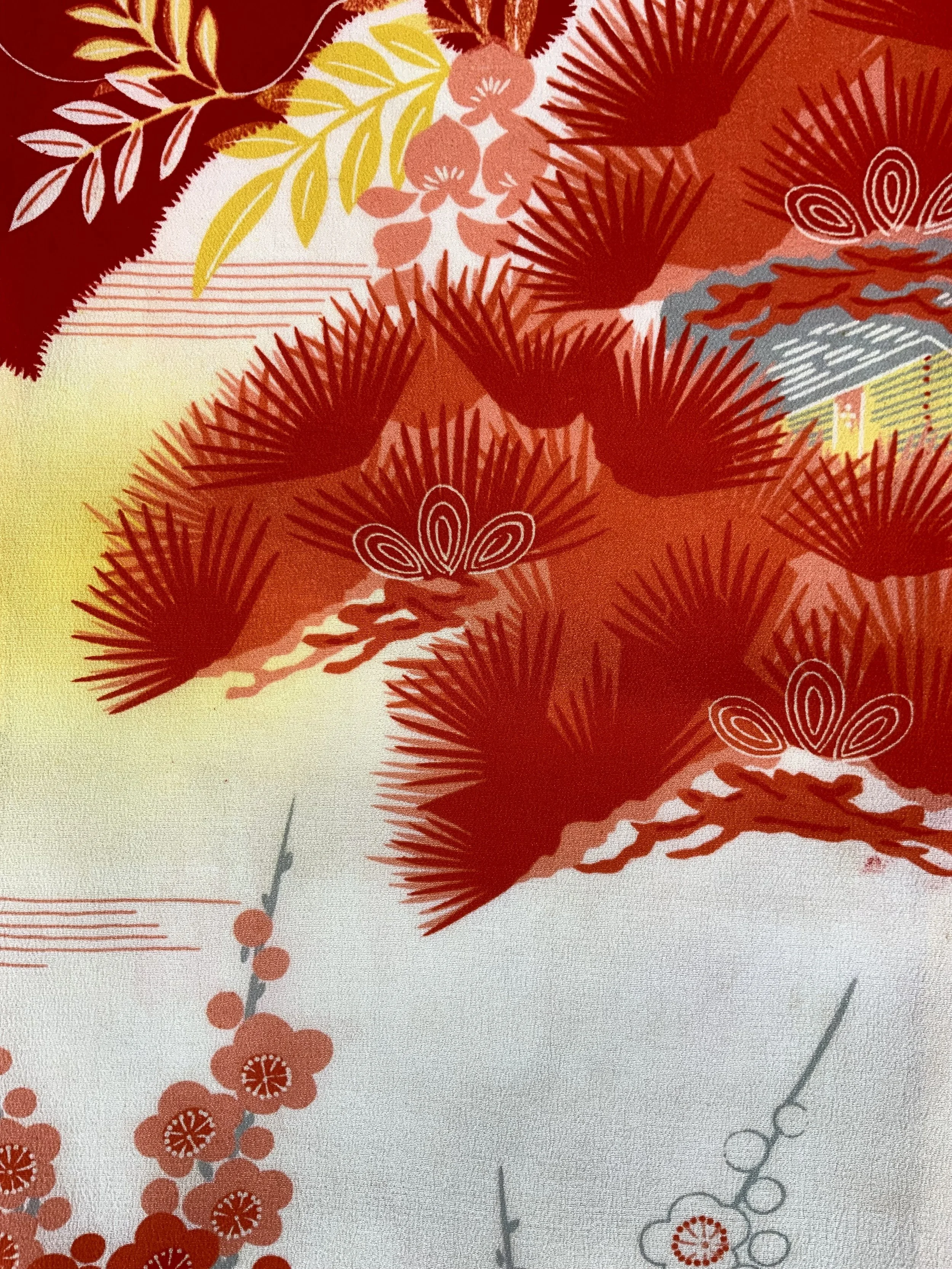 Closeup of vibrant red and yellow scarf with printed blossom design, handmade from repurposed Japanese kimono crepe silk by Kirsty Chivers