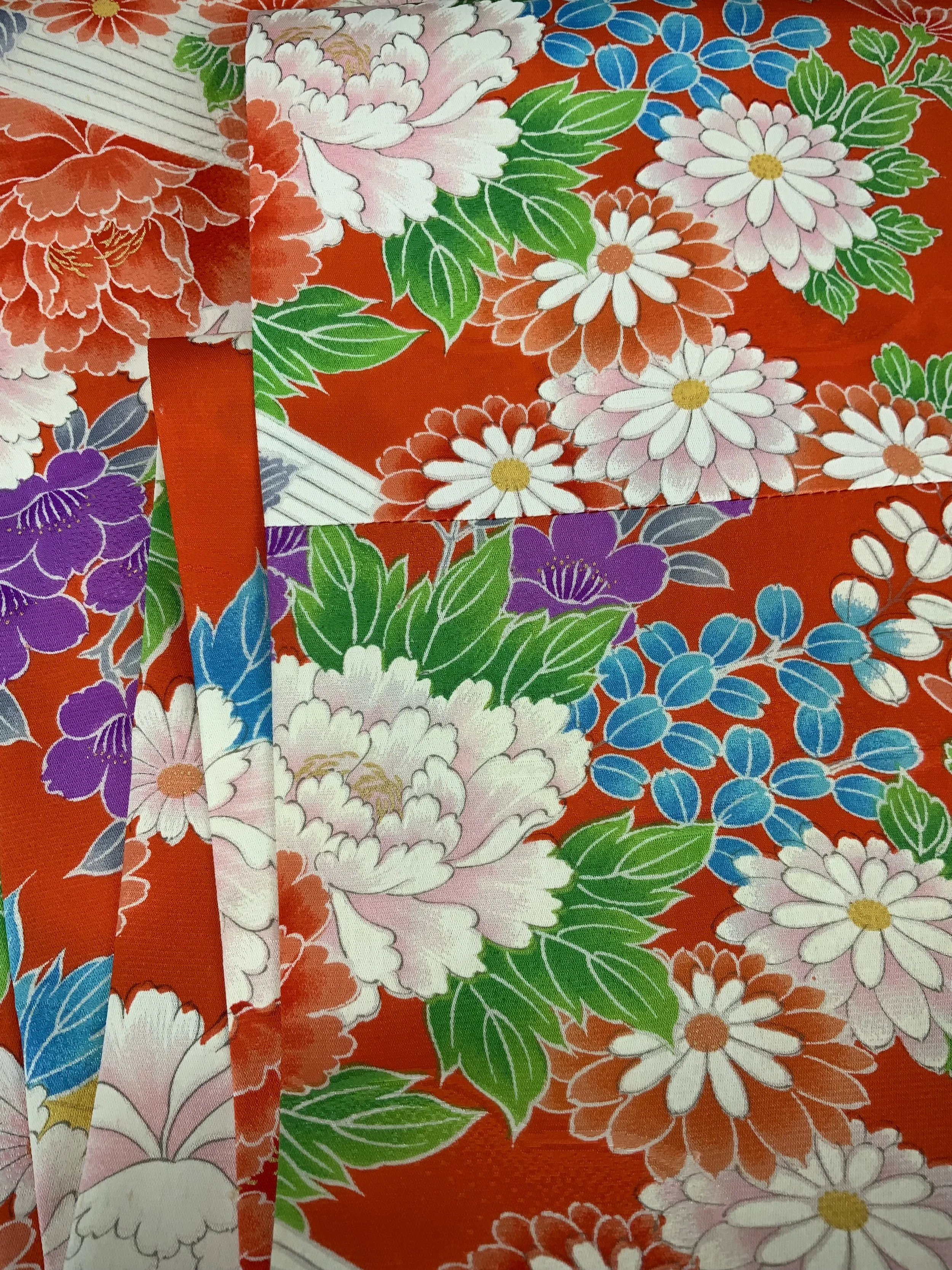 Closeup of orange scarf with blossom print made from rinzu kimono silk by Kirsty Chivers