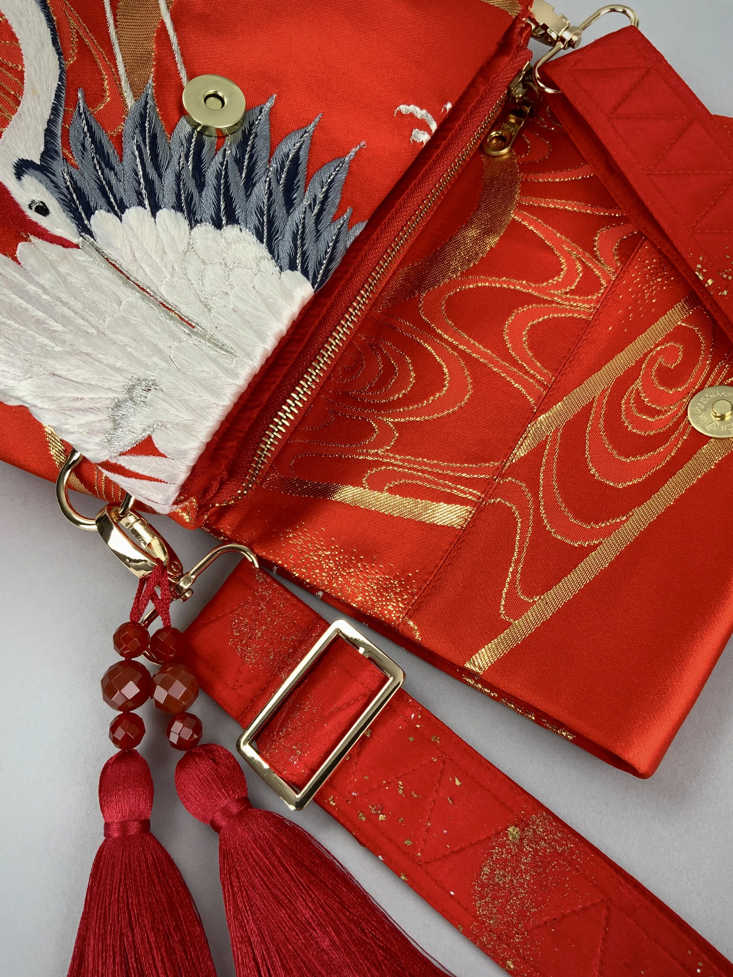 Vermillion red evening bag with embroidered crane design, handmade from vintage kimono silk by Kirsty Chivers