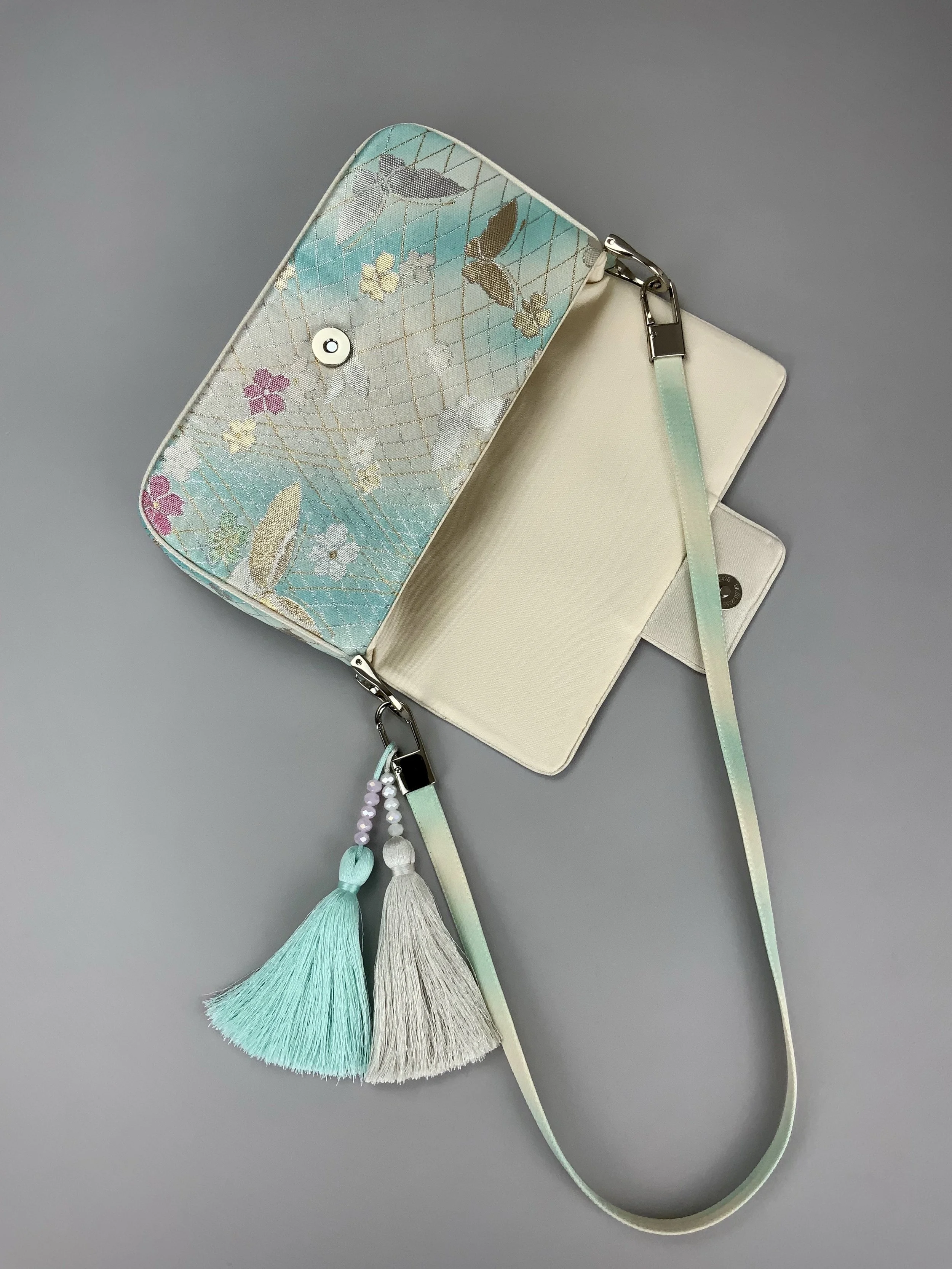 Aqua blue ombre evening bag made from vintage obi silk with pastel gold butterfly and blossom design by Kirsty Chivers