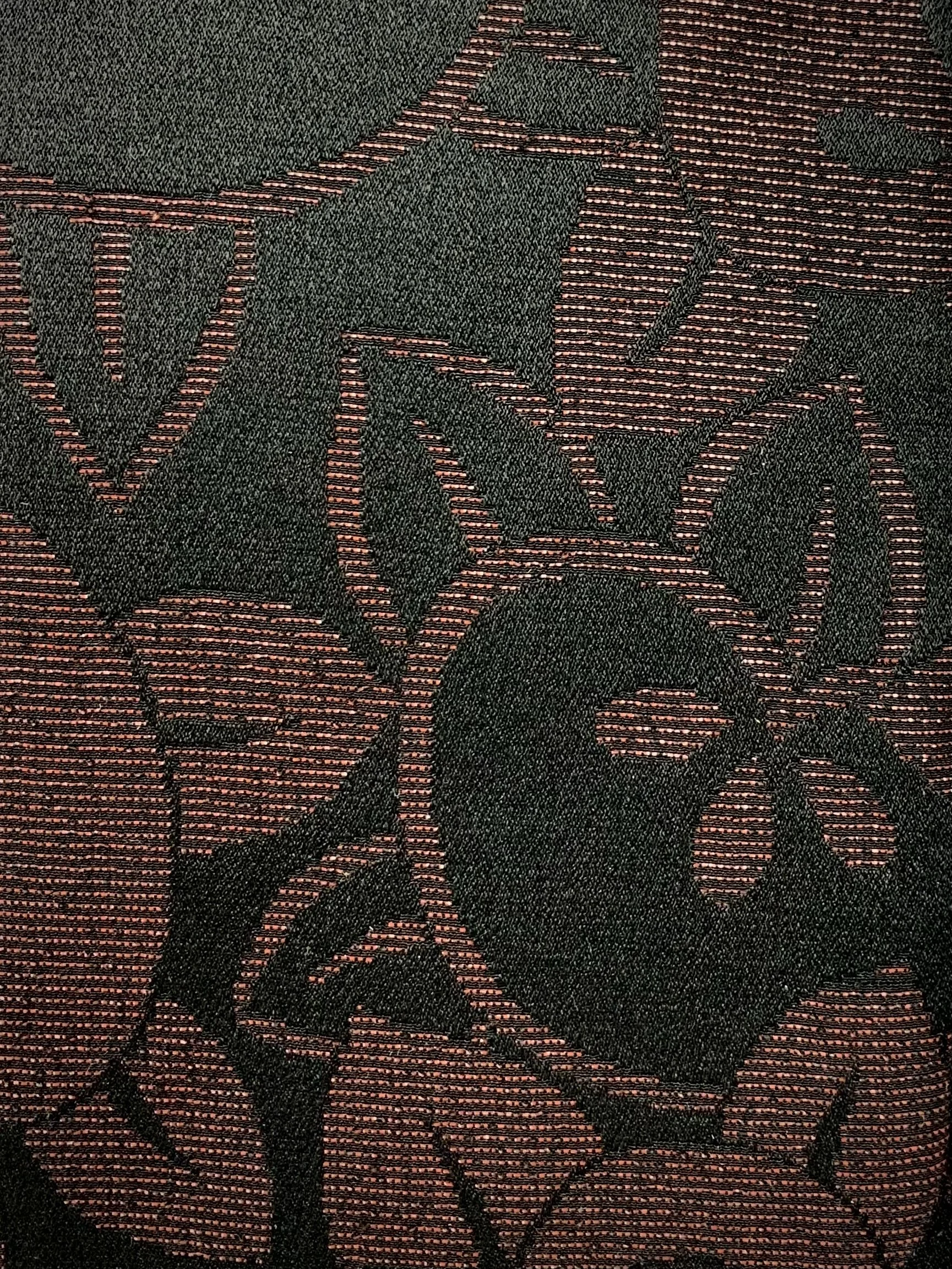 Closeup of glittery black wristlet clutch purse with tassel, handmade from vintage Japanese kimono silk