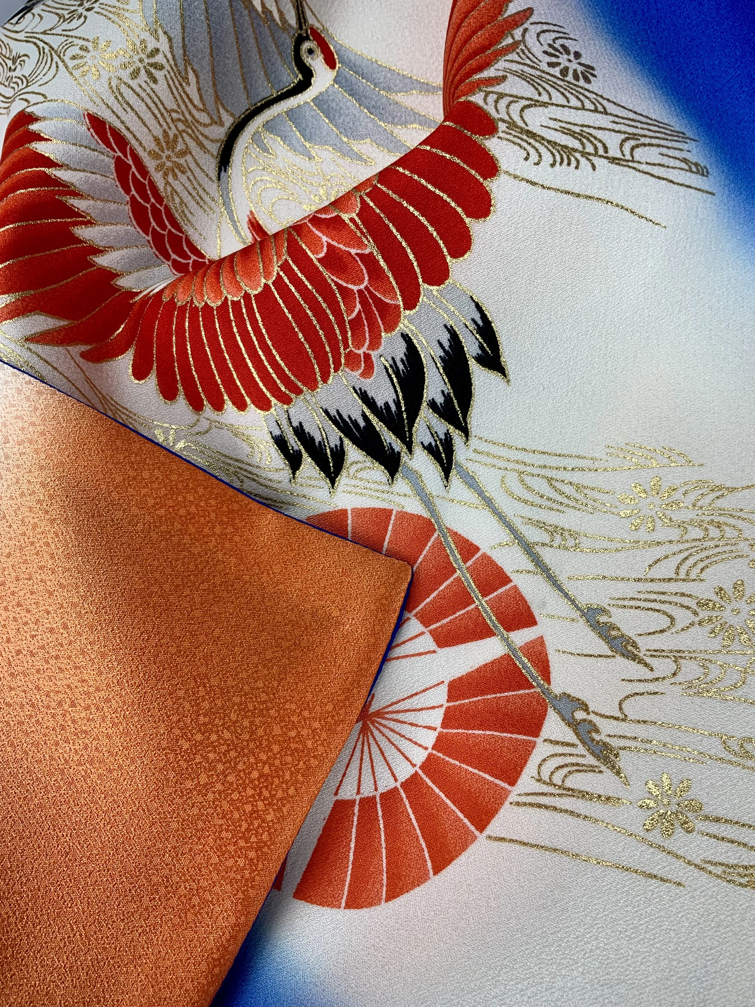Closeup of electric blue silk scarf with Flying Crane print handmade by Kirsty Chivers