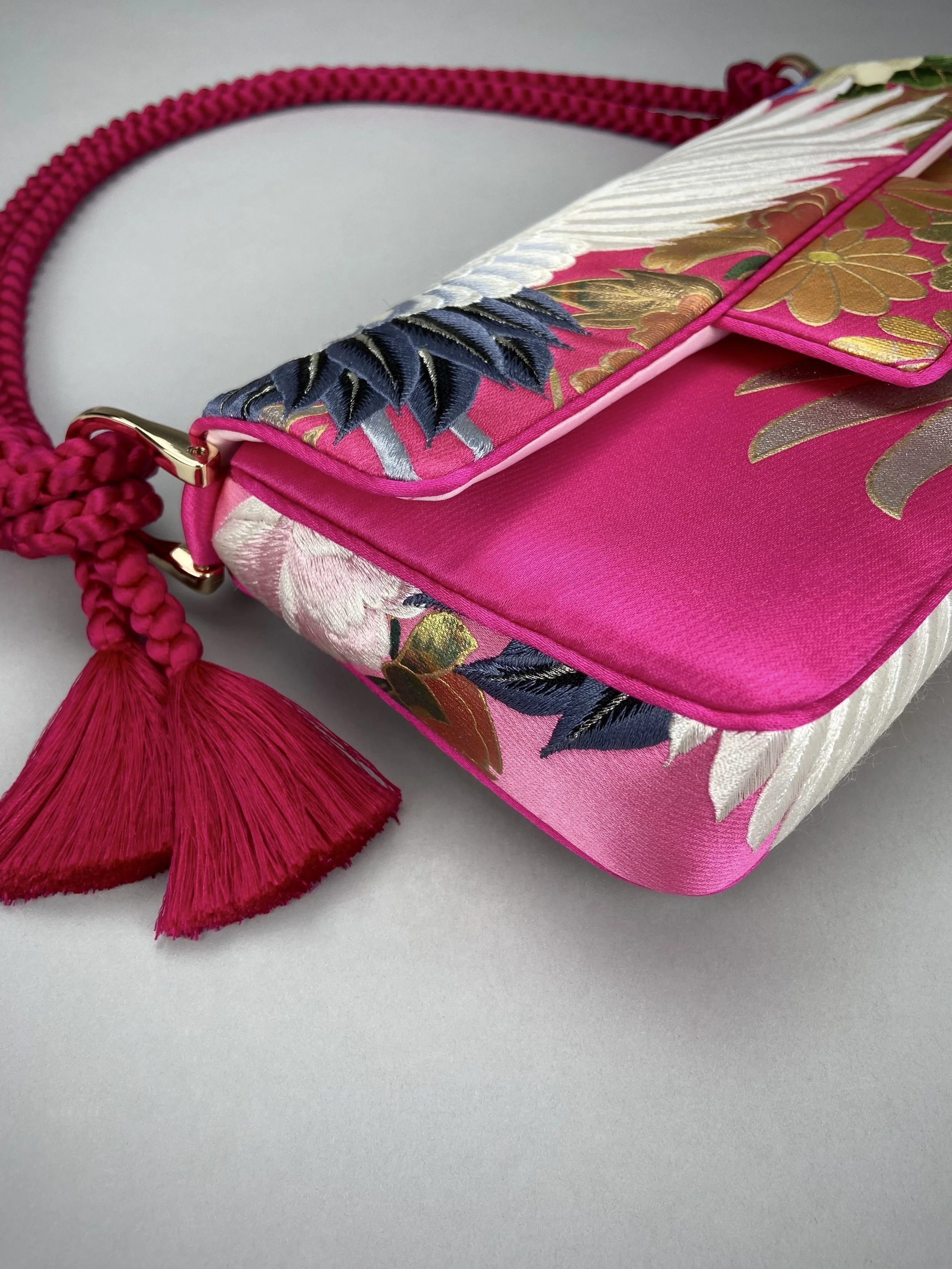 Cherry Pink Crane Feather baguette bag, handmade from vintage Japanese kimono silk with tasseled obijime cord strap by Kirsty Chivers