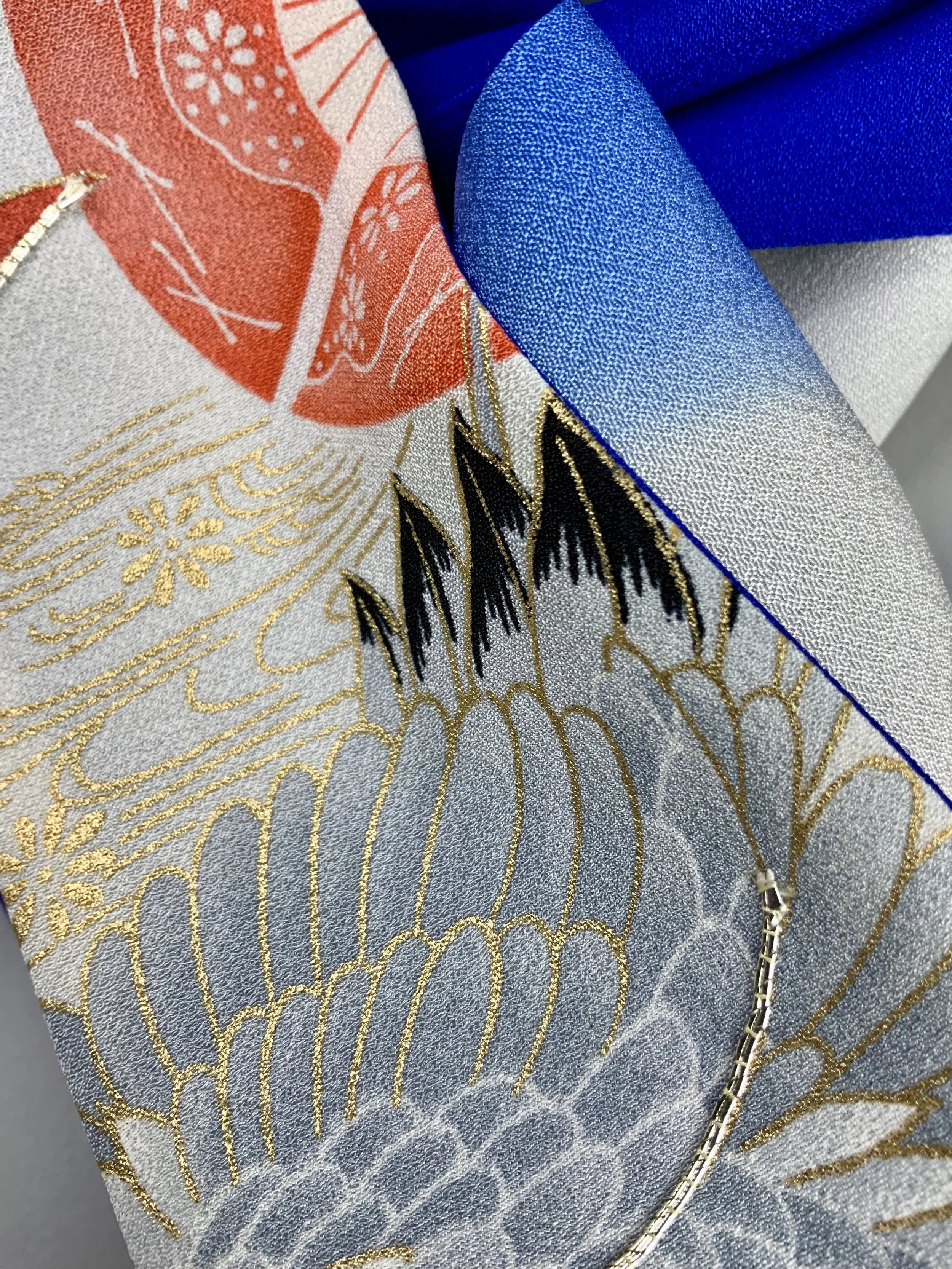 Closeup of blue silk scarf with printed Flying Crane design handmade by Kirsty Chivers