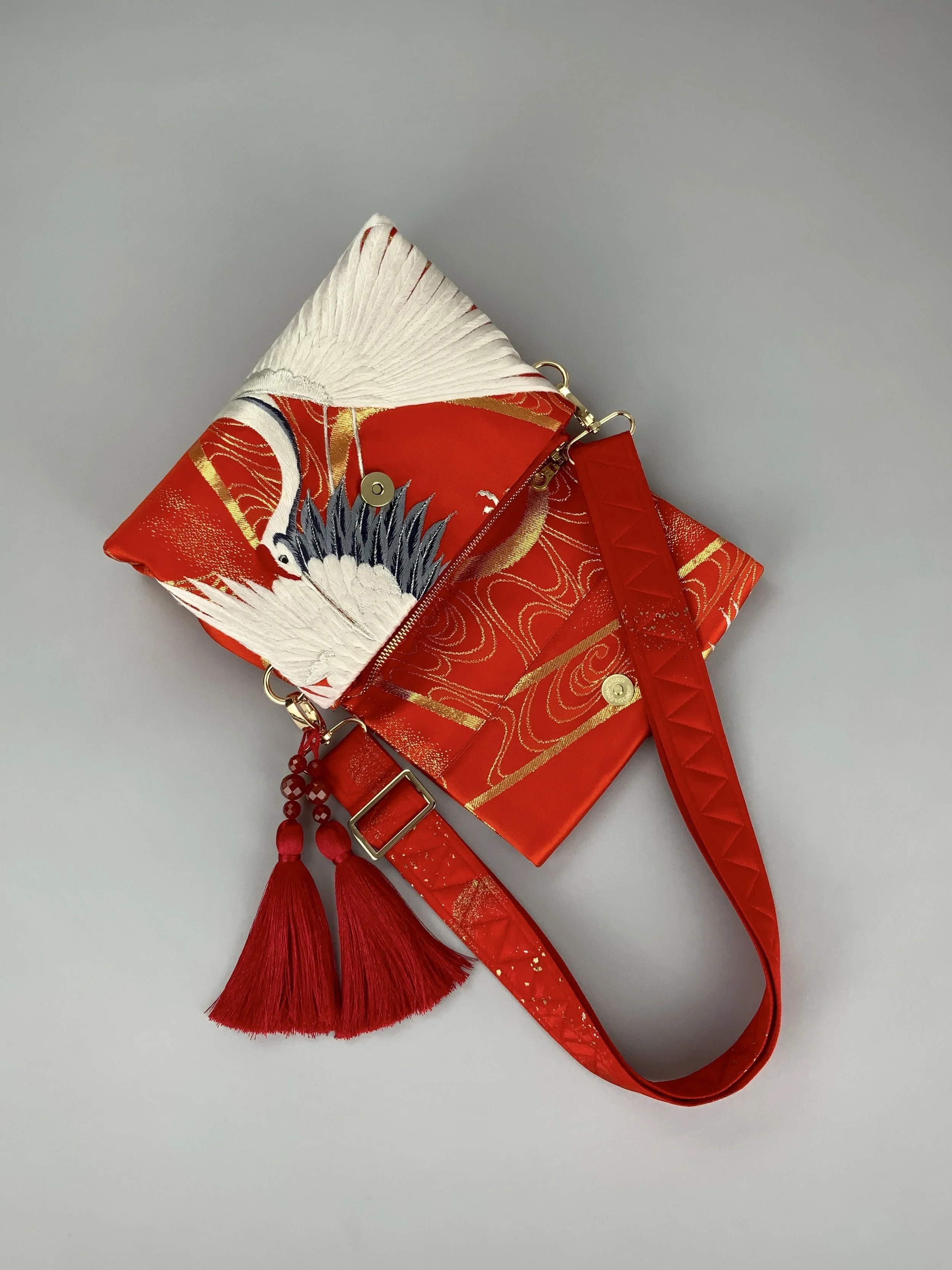 Vermillion red evening bag with embroidered crane design, handmade from vintage kimono silk by Kirsty Chivers